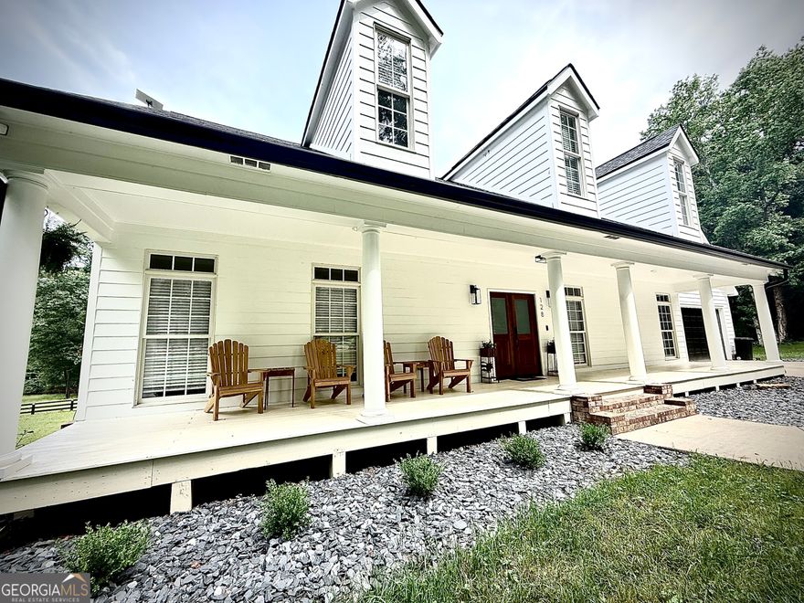 Southern Living at Its Finest in the Towne Lake Area of Woodstock. This beautifully renovated estate home offers 5 bedrooms and 4.5 baths with 6,000 sq ft of fully finished living space, plus an additional 1,500 sq ft of unfinished space for storage or future expansion, nestled on over 5 acres of private land-bring your horses! Every inch of this home has been thoughtfully updated from top to bottom, blending contemporary design with rustic charm. Step inside to an open-concept layout filled with natural light. The chef's kitchen boasts quartz countertops, a brick backsplash, white shaker cabinetry, and a spacious island with a large sink overlooking the family room. The family room features a striking brick fireplace with a cedar mantle, and a wall of windows opens to French doors leading out to a massive deck-perfect for morning coffee or entertaining guests. The oversized primary suite offers a peaceful retreat with a spacious walk-in closet and a luxurious en-suite bath featuring double vanities and a large tile shower. Upstairs, you'll find a full in-law suite complete with two oversized guest bedrooms, a full bathroom, additional laundry, and a private living room. The bonus room over the garage provides the ideal space for a home office or playroom. The fully finished basement includes a home gym with a spa-like bathroom, a second living area with another brick fireplace. Outside, enjoy professionally landscaped grounds, a black-painted fence, a tractor barn, garden area, and open pasture. All just 1 mile from Publix, 2 miles from Lake Allatoona, and minutes from downtown Woodstock. This is the perfect blend of privacy, convenience, and timeless Southern charm.
