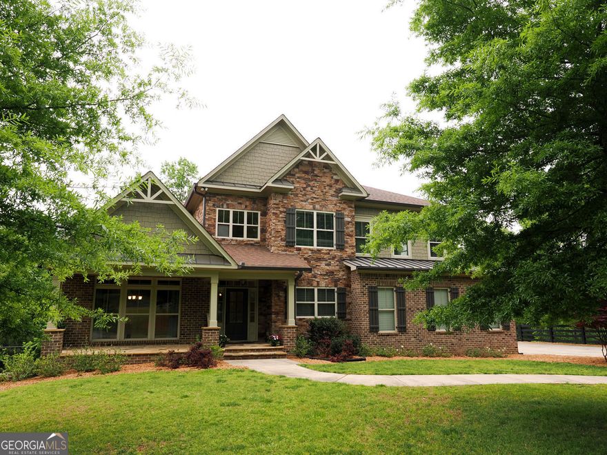 Private Estate Living with Instant Equity Opportunity Nestled on 3.2 pristine acres within an exclusive, six-home community spanning over 29 acres, this stunning 5-bedroom, 5.5-bathroom, 4 car garage residence offers exceptional privacy and timeless elegance just minutes from shopping, dining, and entertainment. Thoughtfully designed, the home features a spacious open-concept layout anchored by a striking stone fireplace, creating a warm and inviting living space perfect for gatherings or quiet evenings. The gourmet kitchen flows seamlessly into the main living areas and onto a screened deck, ideal for enjoying the peaceful natural surroundings and abundant local wildlife. The main-level primary suite serves as a luxurious sanctuary, complete with a spa-inspired ensuite bath and an expansive, walk-through closet that conveniently leads to the large main-floor laundry room-featuring bonus space ideal for an office or craft room. The fully finished, completely accessible basement presents incredible versatility-featuring its own private entrance, a second primary bedroom suite, full kitchen, living area, laundry, bonus room, screened patio area and an additional 2-car garage-perfect for extended guests, multigenerational living, or recreation space. Upstairs, a third primary suite awaits, offering comfort and privacy for family or visitors. The main-level 2-car garage also includes abundant custom storage, catering to both practicality and luxury living. Additional Features Include:  High-End Finishes Throughout  Whole-House Water Filtration System + Reverse Osmosis for Butler's Pantry & Refrigerator  Dual Water Heaters with Recirculation System for Instant Hot Water  Four HVAC Units for Zoned Climate Control  10-Zone Irrigation System  Private 800' Deep Well  Expansive Screened Deck and Lower-Level Screened Patio This extraordinary property is priced below recent appraised value, offering instant equity and a rare opportunity to own a private retreat with exceptional value. Schedule your private showing today and experience the exceptional beauty, quality, and value this estate has to offer.