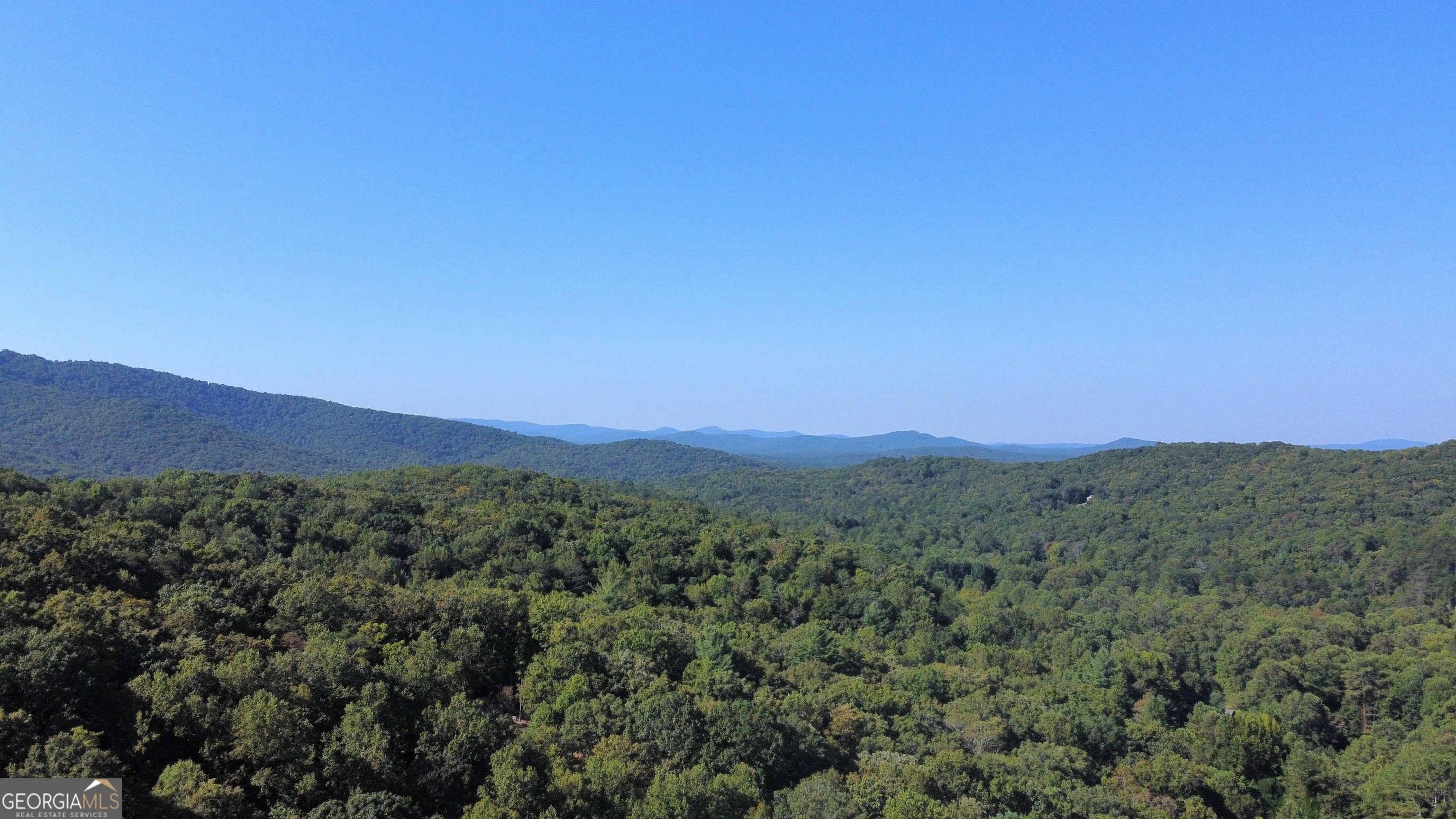 Discover the perfect blend of convenience and serenity with this exceptional mountain lot, thoughtfully prepared and ready for your dream home. The homesite has already been professionally cleared, with a septic system installed and a private well in place-saving you time and expense as you begin your build. Gently rolling and level, the property offers an ideal foundation without the challenges of steep terrain, making construction smooth and straightforward. From the site, enjoy tranquil seasonal mountain views that can be beautifully expanded with selective trimming, creating a sweeping panorama of the surrounding landscape. Nestled in a peaceful setting that feels private yet inviting, this property is a rare opportunity to design and craft the retreat you've always envisioned.