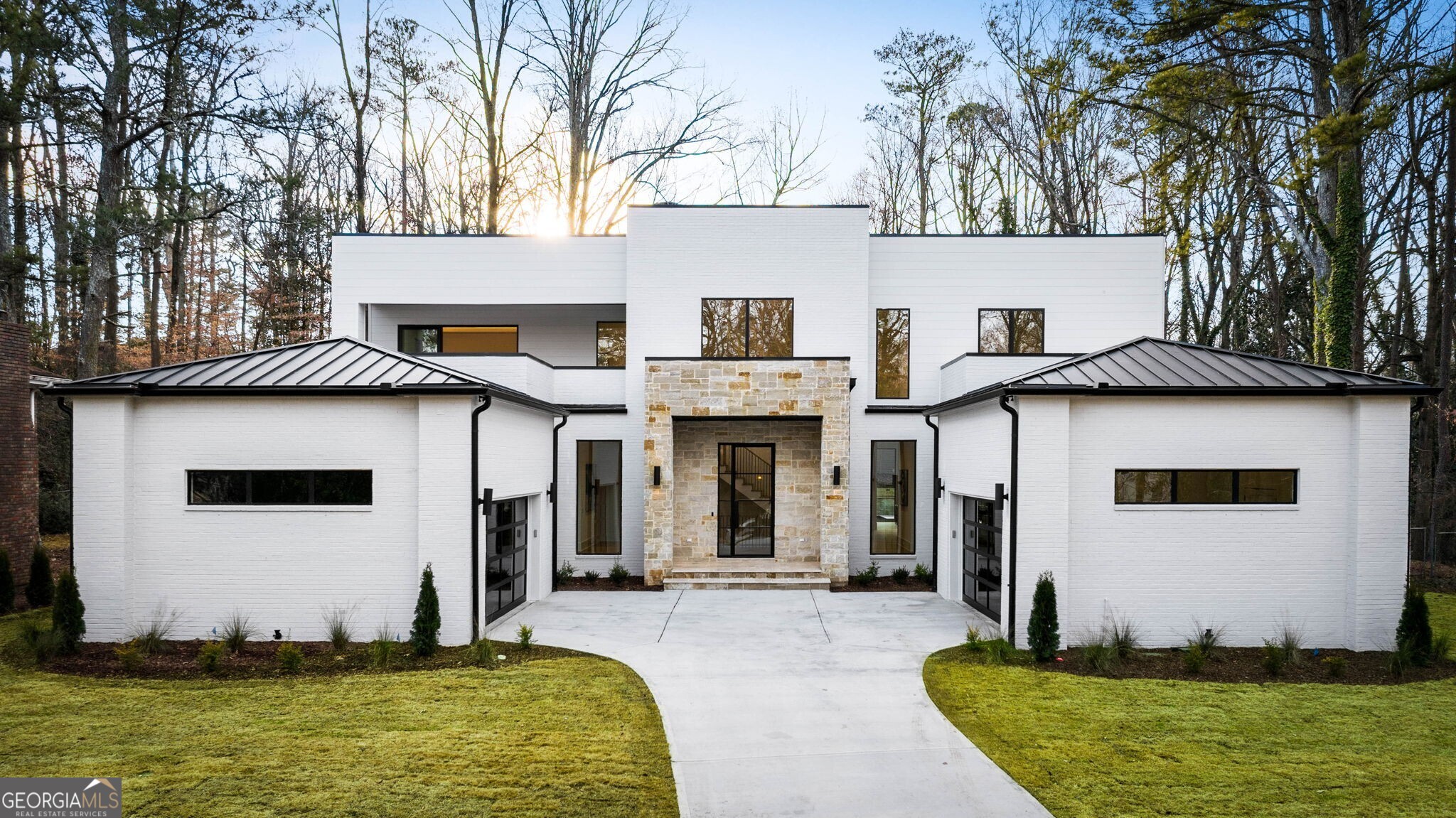 A sophisticated blending of materials and luxurious finishes, a highly refined color palette, and a design distinguished by function and simplicity, combine to offer upscale and modern living and entertaining in this new construction by Six Points Homes. The elegant exterior courtyard and covered front porch open the door to an awe-inspiring 2-story foyer inviting entrance to an intimate and homey haven with an airy, open and free-flowing floor plan. The family room is highlighted by 2 feature walls - an amazing modern linear cozy fireplace wall - as well as a modular wall to display treasured objects. Walk-out through sliders to serenity on the covered porch with outdoor fireplace for al fresco dining or relaxing alongside the heated pool and hot tub in the private fenced backyard oasis professionally landscaped with irrigation. The impressive gourmet kitchen delivers an incredible layout with 2 spaces for the serious cook and entertainer for prep and entertaining ease. One space includes the high-end Wolf and Thermador appliances with expansive beautiful natural white oak soft close cabinets and quartzite waterfall island. The other is a huge walk-in pantry / scullery with more cabinetry storage, and an additional dishwasher. The kitchen/dining area is elevated by a lounge area with wet bar and beverage cooler offering facilities for guest hospitality, or a relaxing moment. This home features 2 Primary Suites. The Main Floor Primary Suite offers a retreat and indulgence with a nature view sitting area with wet bar, a barn door entry to a spa-like bath providing an expansive shower with 2 separate shower heads and controls, niche lighting, a soaking tub, 2 floating sinks with backlit mirrors, 2 water closets, and a huge dressing room for 2 with built-in storage units. Find an additional main floor bedroom en suite with walk-in closet, 2 offices, a powder room, a laundry room, mudroom area with cubbies, and 2 entrances from each 2-car garage. The 2nd floor primary suite features a beverage center, walk-in closet with custom built-ins, soaking tub, shower with niche lighting, dual sink vanity, backlit mirror, and a covered outdoor balcony. The second floor also includes the spacious laundry room with lots of cabinets, a linen closet, and 4 additional bedrooms en suite with walk-in closets. The basement level includes a recreation room with wet bar and cabinetry, access to wine cellar area, and another office/bedroom/gym with full bath and walk-in closet. To enhance design elements throughout modern amenities include lit stairways, cove lighting, floating shelves with built-in lighting, and beautiful custom built-ins to offer organized storage options. This magnificent home is in the Brittany subdivision near Historic Brookhaven and schools. This is core Brittany, with a priority membership available to The Brittany Club, with pool, tennis courts, etc.; all overlooking beautiful 27-acre Silver Lake. This exquisite home is also near all shopping and dining amenities offered by TOWN Brookhaven, Dresden Ave, and Chamblee. Treat yourself to a showing today!