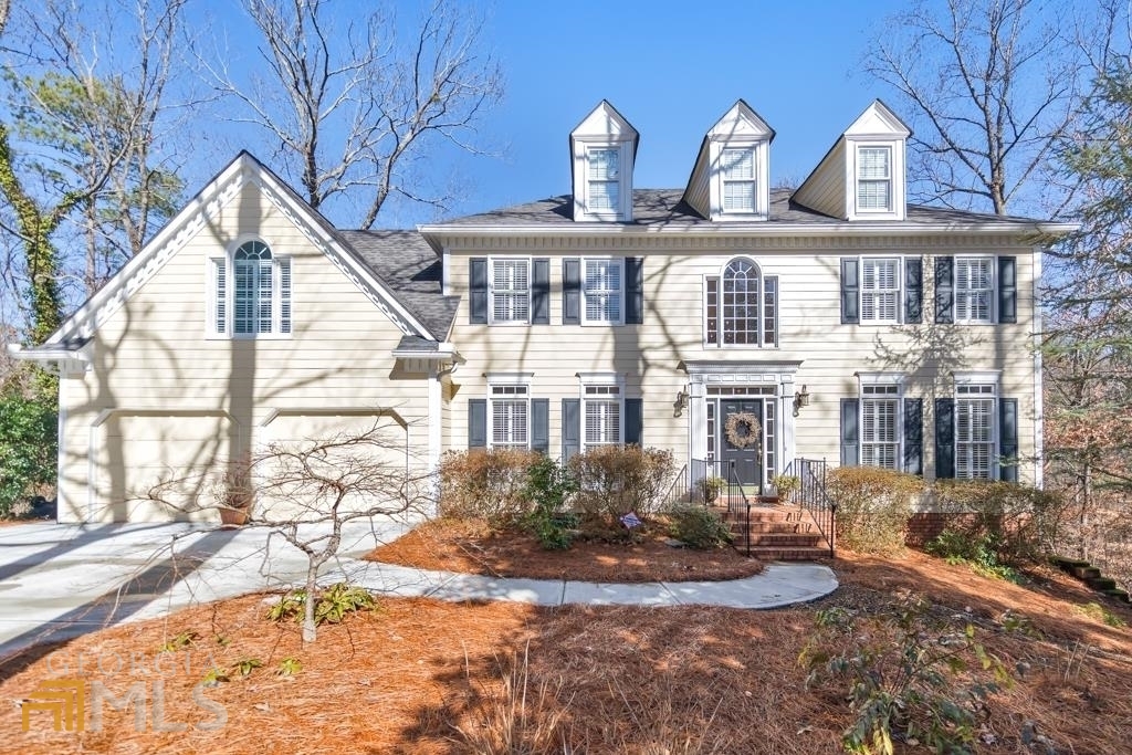 Beautiful 5 bed / 3.5 bathroom home in the Carriage Park community in Roswell! The main floor is an entertainer's dream! With a formal dining room, keeping room, spacious family room, and a very bright sunroom, this main floor plays host to various aspects of keeping your guests engaged and comfortable. Cozy up by the fireplace in the family room and enjoy a good movie, or spend time in the keeping room and share laughs with your family! The kitchen has views into both the dining room and family room. It is equipped with granite countertops, white cabinets, up to date appliances, and a gorgeous island in the middle of the space. This kitchen will serve a perfect place to enjoy cooking with family and friends alike. Take one of the two staircases to the upstairs living quarters where you will find 4 bedrooms and two full bathrooms. The master bedroom is at one end of the hallway and it has an attached walk-in closet and full bathroom with a stand-alone tub, his and her vanity, and a separate shower! The upstairs has its own laundry room to make washing and drying a breeze for you and your guests. The 3 spacious secondary bedrooms share a full bathroom. The lower level can be used as a flex space as it houses two large rooms and a full bathroom with the potential to hook up another washer and dryer. There are two rear decks attached to the home that overlook a scenic, wooded backyard with a creek running through. Roswell address, Cobb schools and taxes! You do not want to miss this!