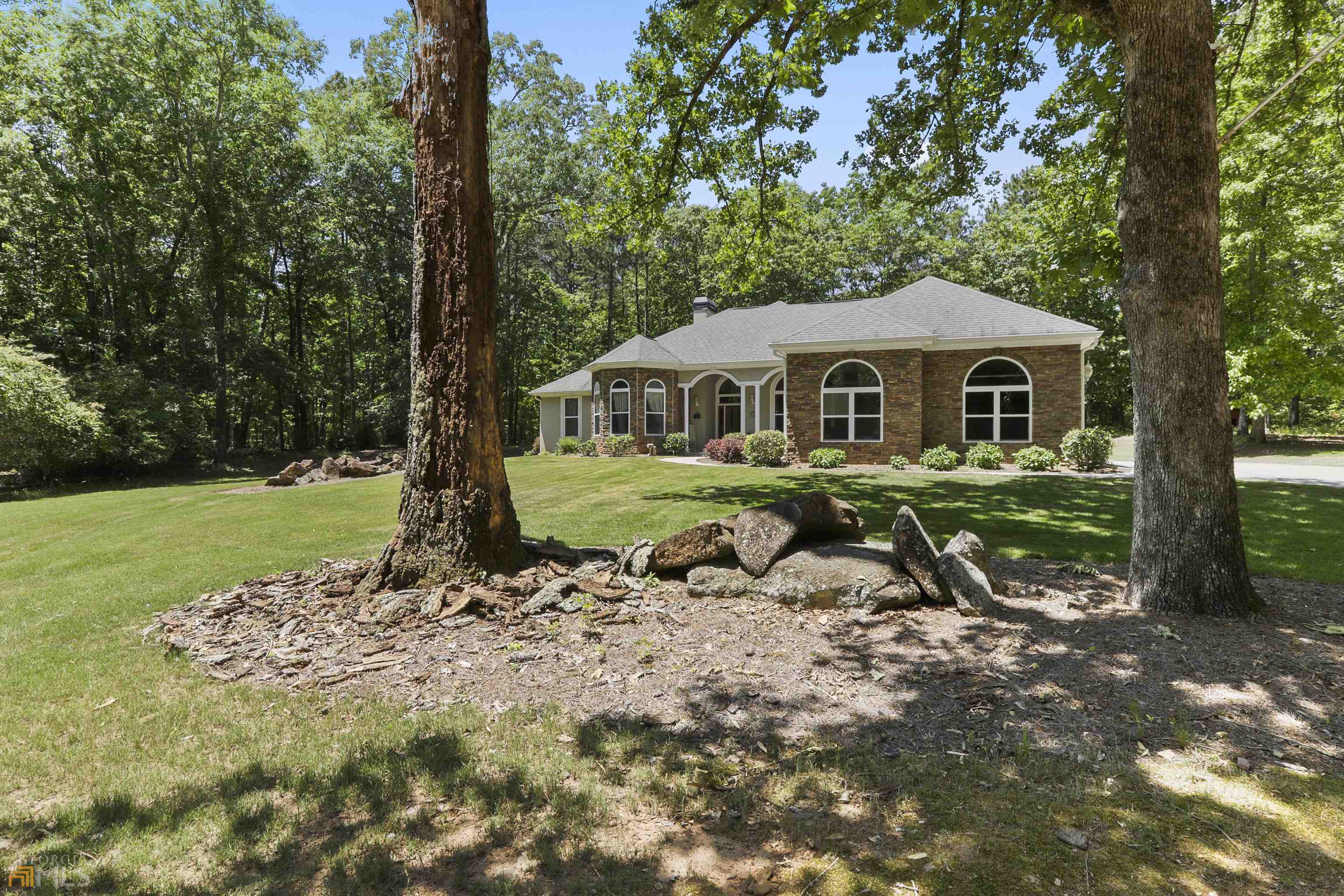 WELCOME TO FAYETTEVILLE. Just minutes from Trillith(Pinewood Studios), Dining and shopping. This amazing custom built home sits on a private 6 acre lot that is beautifully wooded. A fully paved driveway brings you into the breathtaking view of this stucco and stone custom built ranch. This home boasts over 3,000 sq ft of beautiful and well lit living space. The use of many double pane high efficient windows throughout the house gives this property such a calm and peaceful feeling. Enjoy your morning coffee on the screened in back porch and revel in your very private and secluded backyard. No expense was spared in the building of this awesome home. The custom upgrades include kitchen cabinets, walk in closets, and floor plan. This house is not a cookie cutter house in the slightest bit so hurry and schedule your showing through showing time or call Steven Cooper 678-595-4476