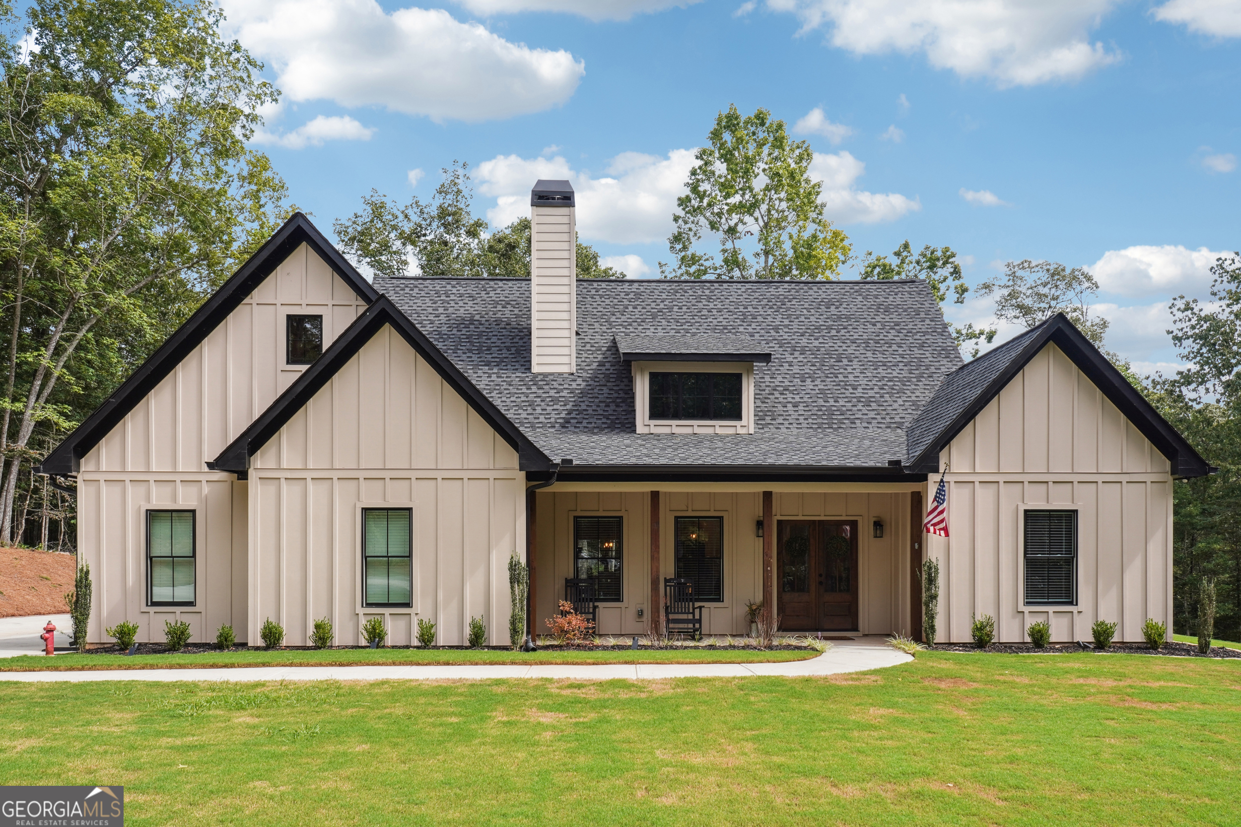 This beautiful home at 7450 Tyree Road in Winston, GA, is the perfect mix of cozy country living and modern style. With 4 bedrooms, 2 baths, and a spacious 5.16-acre lot, there's plenty of room to spread out and enjoy life. The property is very private, and the house is surrounded by beautiful hardwood trees. As you step inside, you will notice the open layout, which is perfect for living and entertaining. The living room has tall, vaulted ceilings and a stunning wood-burning brick fireplace that makes the whole room feel warm and inviting. The kitchen is a dream come true for anyone who loves to cook. It features stylish white cabinets, gorgeous granite countertops, and a big farmhouse sink. There's even a pot filler over the stove and a herringbone tile backsplash that adds a touch of class. The kitchen island is the perfect spot for a quick breakfast or a casual gathering. The master bath features a shower with large tile. But the fun doesn't stop inside! Step out onto the covered back patio where you'll find a full outdoor kitchenette and another wood-burning fireplace-perfect for a chilly night. The ceiling fan keeps things comfortable on hot summer days. The backyard is a great space for outdoor games or gardening. The home also includes a 2-car garage, and a dedicated 100-amp electrical service on the back of the house, allowing for easy installation of a pool, workshop, or hot tub without interfering with the existing power. For those who travel often, you'll love the location. This home is just a short 38-minute drive from Hartsfield-Jackson Atlanta International Airport, which is about 30.8 miles away. It's also conveniently located just a 17-minute drive, about 9.2 miles, from Interstate 20. For golf lovers, Saint Andrew Golf Course is only a 9-minute drive away, about 3.3 miles. It's the perfect combination of a peaceful, secluded home that's still close to everything you need.