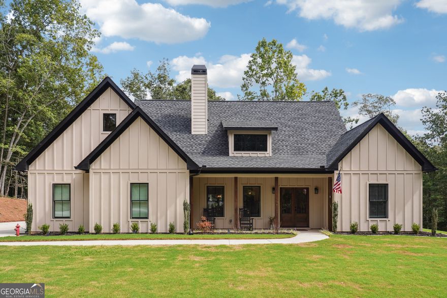 This beautiful home at 7450 Tyree Road in Winston, GA, is the perfect mix of cozy country living and modern style. With 4 bedrooms, 2 baths, and a spacious 5.16-acre lot, there's plenty of room to spread out and enjoy life. The property is very private, and the house is surrounded by beautiful hardwood trees. As you step inside, you will notice the open layout, which is perfect for living and entertaining. The living room has tall, vaulted ceilings and a stunning wood-burning brick fireplace that makes the whole room feel warm and inviting. The kitchen is a dream come true for anyone who loves to cook. It features stylish white cabinets, gorgeous granite countertops, and a big farmhouse sink. There's even a pot filler over the stove and a herringbone tile backsplash that adds a touch of class. The kitchen island is the perfect spot for a quick breakfast or a casual gathering. The master bath features a shower with large tile. But the fun doesn't stop inside! Step out onto the covered back patio where you'll find a full outdoor kitchenette and another wood-burning fireplace-perfect for a chilly night. The ceiling fan keeps things comfortable on hot summer days. The backyard is a great space for outdoor games or gardening. The home also includes a 2-car garage, and a dedicated 100-amp electrical service on the back of the house, allowing for easy installation of a pool, workshop, or hot tub without interfering with the existing power. For those who travel often, you'll love the location. This home is just a short 38-minute drive from Hartsfield-Jackson Atlanta International Airport, which is about 30.8 miles away. It's also conveniently located just a 17-minute drive, about 9.2 miles, from Interstate 20. For golf lovers, Saint Andrew Golf Course is only a 9-minute drive away, about 3.3 miles.  It's the perfect combination of a peaceful, secluded home that's still close to everything you need.