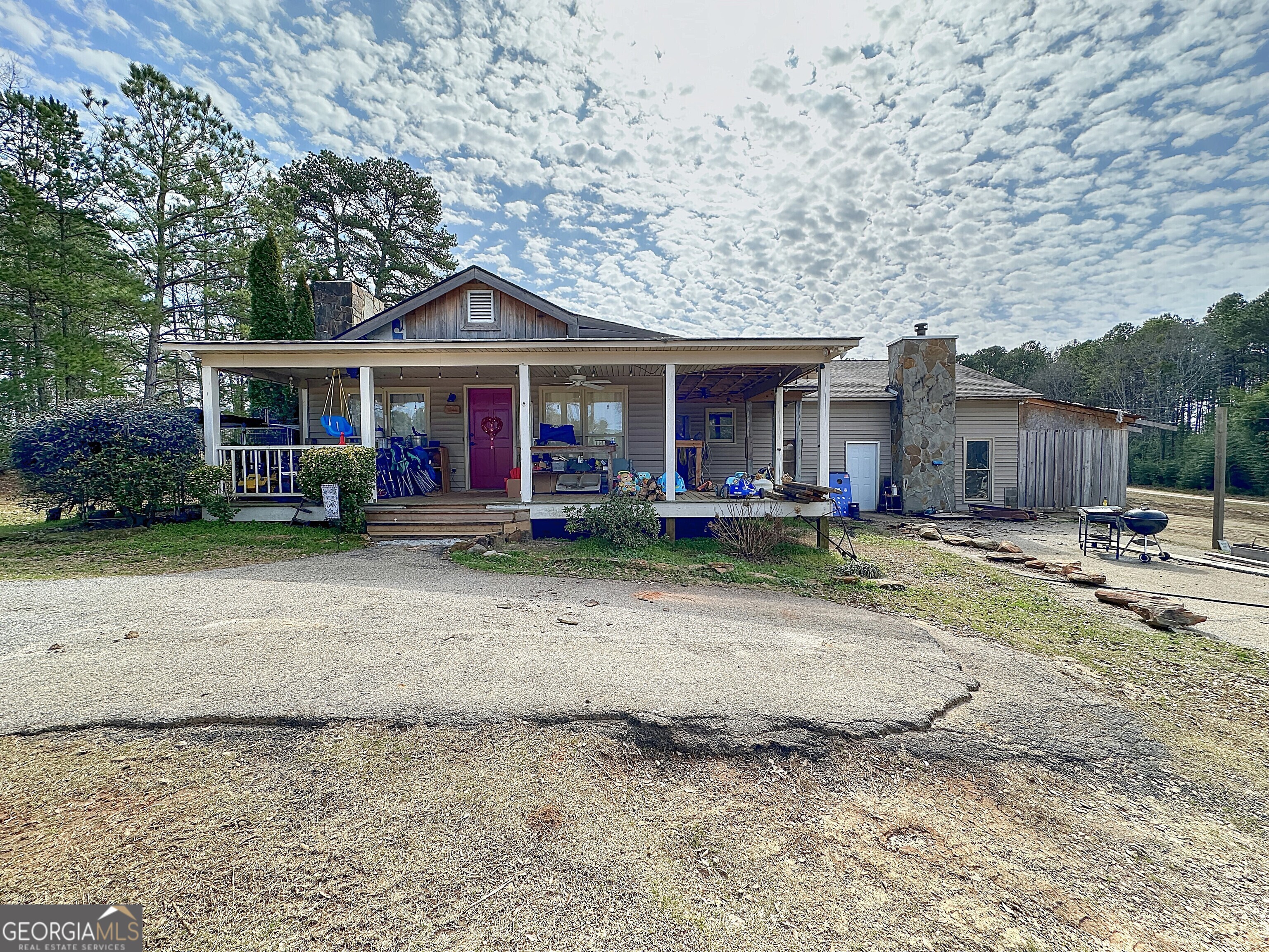 PRIME locations in Troup County and nestled on just over 12 ACRES. It has small pond perfect for a catfish hole, Aprox 288 ft of road frontage to Hwy 109, circular driveway, and Long Cane Creek flows on the back side of the property. The home has a huge rocking chair front porch, 4 year old roof, rustic style with rough cut wood walls, tin and wood ceilings, two fireplaces, country kitchen, separate dining area and a massive master suite currently under construction which opens up to a covered porch overlooking the small pond. The new owner can come in and put their own touches on this home. Very convenient to the interstate, shopping and dining... It has Features include a 30x40 red iron, fully insulated shop with its own separate meter, 12 Ft. roll up door, and 12 inch thick slab that could be leased in addition to this home.