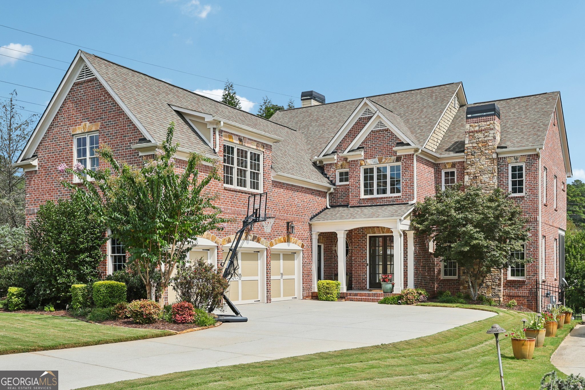 Executive Luxury in East Cobb's Premier School District. This isn't just a home-it's a lifestyle statement. Perfectly positioned in an exclusive East Cobb cul-de-sac and zoned to Davis Elementary, Mabry Middle, and Lassiter High-three of Georgia's most sought-after schools-this immaculate 3-sided brick executive estate offers resort-style living with unmatched convenience to Marietta, Woodstock, and Roswell. From the moment you arrive, the professionally landscaped grounds and architectural lighting set the tone for refined elegance. The heated saltwater gunite pool with jacuzzi that waterfalls into the pool takes center stage in the backyard oasis, surrounded by multiple outdoor living areas: a stone pool deck for sun-soaked afternoons, a shaded terrace-level lounge, and a covered screened porch-perfect for morning coffee or a sunset toast. A sun ledge with in-pool chairs makes it just as perfect for children's play as for adult relaxation. Inside, a grand foyer opens to an open floor plan designed for both elegance and ease. Hardwood floors flow throughout the main living spaces, complemented by detailed crown molding and a formal dining room fit for twelve. The fireside family room opens to the screened porch, while the keeping room-with its coffered ceiling, custom built-ins, and stone fireplace-frames tranquil views of your private backyard retreat. The gourmet kitchen is a chef's dream, with stainless steel appliances, custom stained cabinetry, expansive granite counters, a breakfast bar, and a sunny eat-in nook. Upstairs, the primary suite is a showpiece-an elegant oversized bedroom with a private sitting room, spa-like bath featuring a soaking tub and separate shower, and an expansive walk-in closet. A junior primary suite with private en suite bath offers comfort for guests or multi-generational living, while two additional oversized bedrooms share a spacious Jack-and-Jill bath. An upstairs media room provides the perfect spot for movie marathons, gaming, or homework space. The finished terrace level is an entertainer's dream, with high ceilings, luxury vinyl plank floors, a billiards area, guest suite with full bath, and abundant storage. The terrace-level media room is tailor-made for hosting-whether it's movie night with friends or watching the big game on the weekend. Step right outside to your illuminated pool and jacuzzi, where every evening feels like a private resort under the glow of curated exterior lighting. Every detail of this home reflects exceptional craftsmanship, impeccable condition, and timeless design-the perfect blend of prestige, comfort, and convenience. This is more than a home-it's the reward for all you've accomplished.