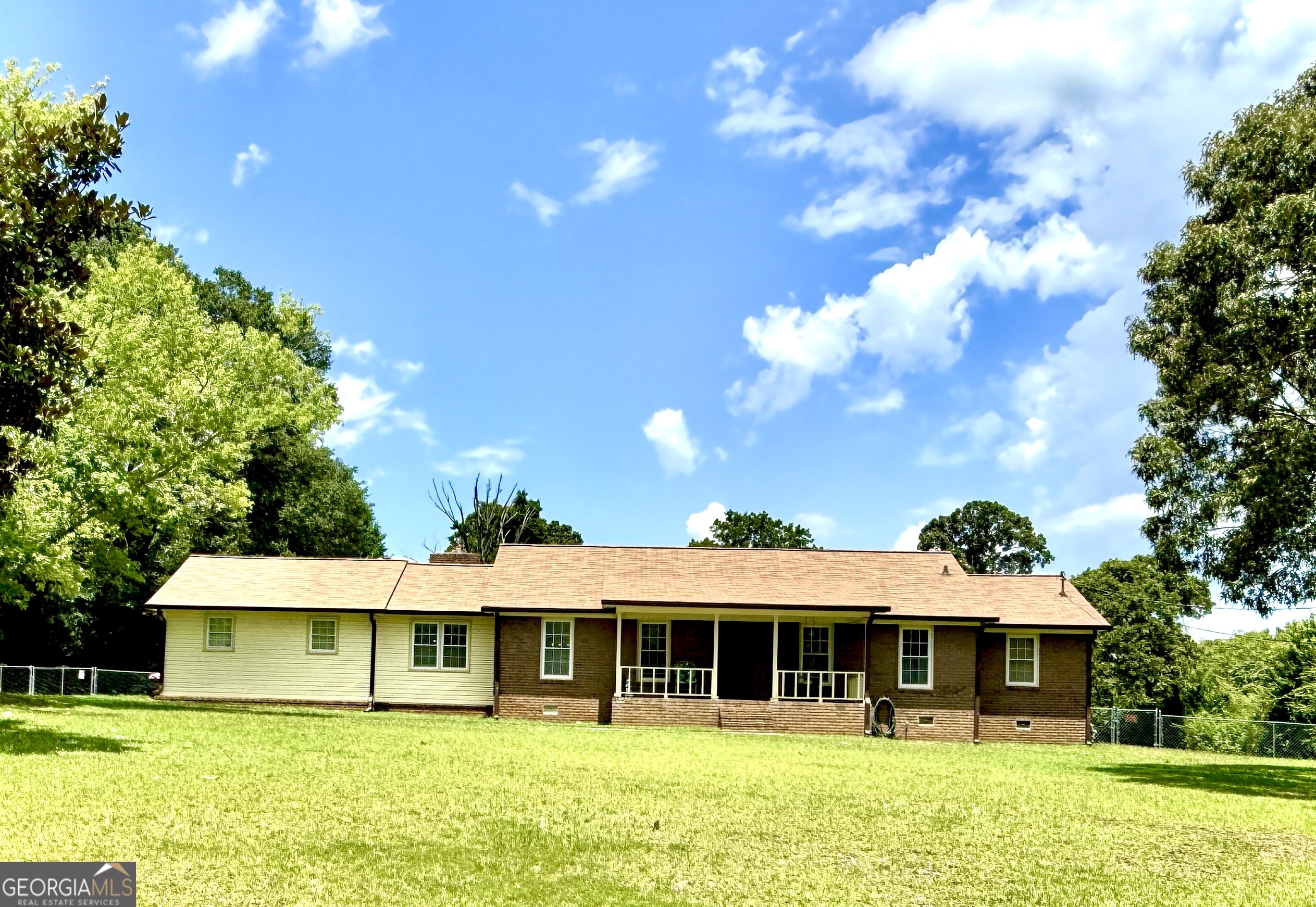 Charming 4-Sided Brick Ranch on a Private 1-Acre Lot! Welcome home to this beautifully maintained 3-bedroom, 2-bath ranch nestled on a spacious, 1-acre lot offering privacy and tranquility. This solid 4-sided brick home features a large eat-in kitchen equipped with stainless steel appliances-perfect for family meals and entertaining. Enjoy multiple living spaces with a generous living room and a cozy den/family room ideal for gatherings. Step outside to relax on the inviting front porch complete with a classic porch swing, or unwind on the covered back porch overlooking the fenced backyard. 2-car garage, large workshop, and multiple outbuildings-including a storage unit big enough to park an RV or boat, plus two additional smaller workshops/storage sheds. Don't miss this unique opportunity to own a well-cared-for home with space, storage, and peaceful surroundings-all just minutes from local conveniences.