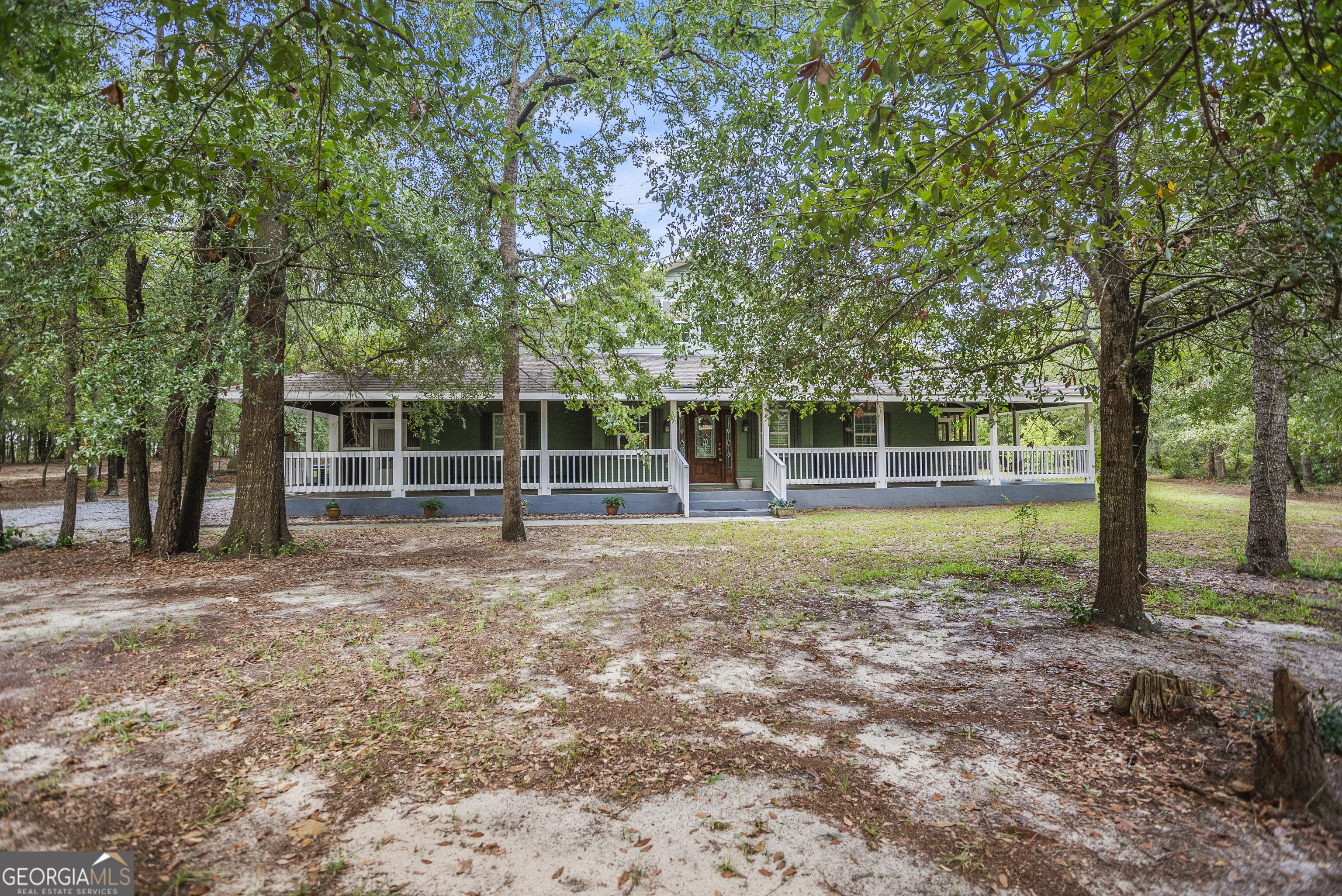 If you've been searching for a spacious, one-of-a-kind home with room to grow and entertain, look no further! This stunning Southern charmer offers 4 bedrooms, 5 full bathrooms, and a wraparound porch on all sides-perfect for morning coffee or sunset views. The main floor features a generously sized master suite complete with his and hers closets and an unbelievable walk-in laundry room just steps away. Two additional spacious bedrooms, each with private full bathrooms, are located on the opposite side of the home for added privacy. The open-concept living area flows seamlessly into a massive kitchen built for entertaining, featuring two refrigerators and two stoves-plenty of room for cooking, hosting, and holiday meals. Upstairs, you'll find a second living room, a fourth bedroom, and another full bathroom. Both sides of the upper level open into walk-in, floored attic storage areas, providing convenient access to plenty of extra space. Step out back to the screened-in porch, designed for gathering and relaxing, complete with its own full bathroom. Just beyond is a perfectly sized family pool and a detached storage building, ideal for hobbies or yard equipment. Situated on 4 peaceful acres, this custom-built, one-owner home offers the serenity of the countryside while still being minutes from I-16 and just 30 minutes to the Mega Hyundai Plant. All original house plans convey with the sale, showcasing the homeowner's attention to detail throughout. Don't miss the chance to own this rare gem-schedule your private showing today! Michelle Lands | 912-213-0316
