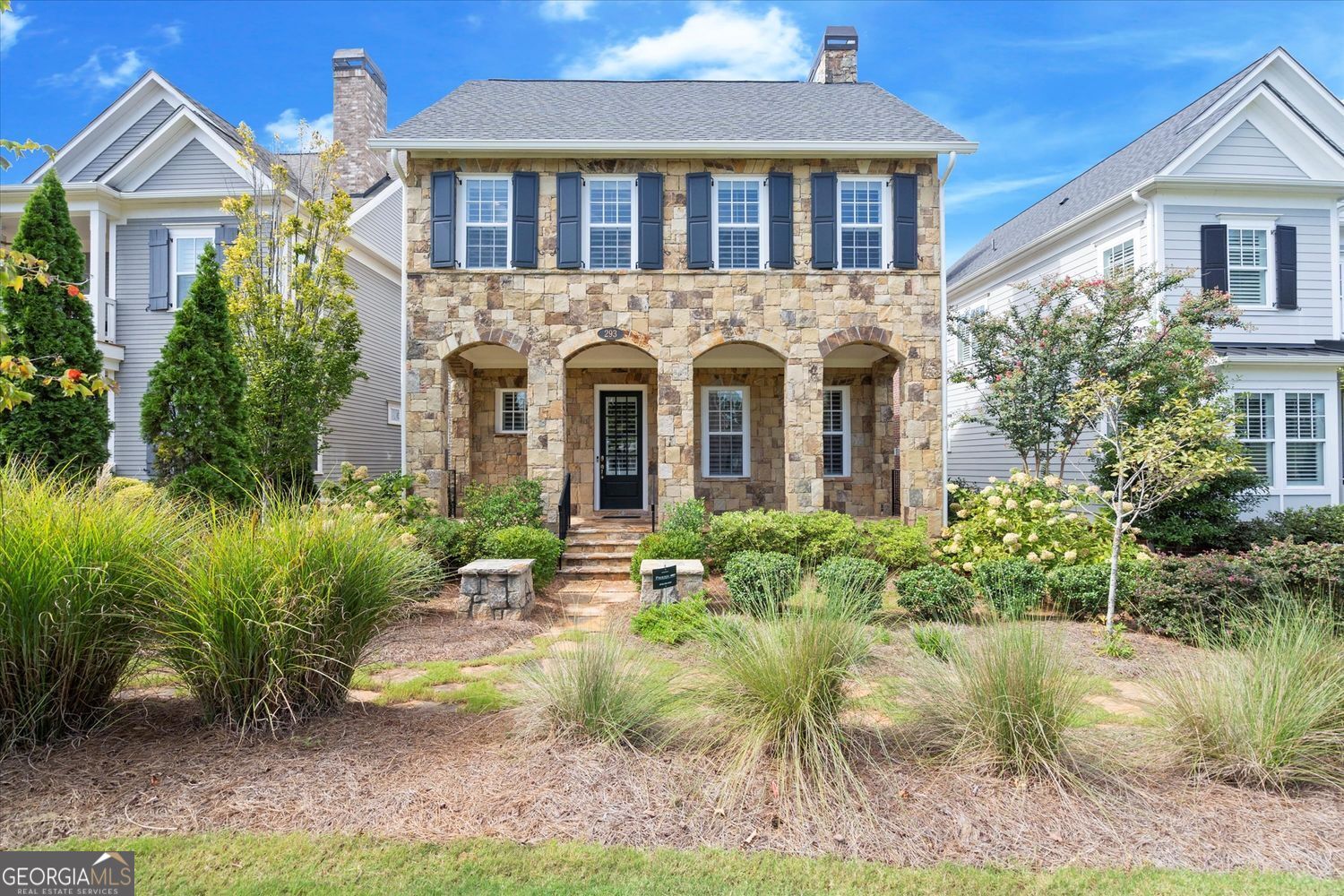 293 Thompson Street, Alpharetta, GA - A rare opportunity to own a luxurious, stone-clad residence that marries timeless elegance with prime walkable location. This stunning home-reminiscent of an English stone cottage-is the exceptional Riverside floor plan with a fully finished terrace level, offering over 3,100 square feet of sophisticated living space. Exterior & Location Nestled in the Foundry neighborhood just steps from the Alpha Loop, this home places you in the heart of Avalon's upscale shopping and dining, and minutes from the vibrant community events in downtown Alpharetta. With the Alpha Loop walking trail just beyond your door, enjoy seamless weekend access to Alpharetta's best. Interior Highlights * Main level: Open and airy with abundant natural light pouring into the family room, centered around a cozy fireplace. The adjacent chef-inspired kitchen flows effortlessly into the formal dining room, creating an ideal space for entertaining. A convenient main-level bedroom with en suite bath offers comfort and versatility. * Upper level: Retreat to the owners' suite, a sanctuary with a luxurious private bath and generous closet space. Two additional bedrooms share a well-appointed full bathroom. * Terrace level: This fully finished basement expands your living possibilities-featuring a flex room with its own bathroom that's perfect as a fifth bedroom, media room, or private office. Additional Features * Exquisite stone exterior, evoking an English cottage aesthetic. * Two-car garage, plus a dedicated golf cart garage-perfect for local errands or a fun spin to Avalon. * High-end interior finishes, including 10-foot ceilings, finely crafted cabinetry, and open-concept design that enhances traffic flow throughout the home * This home reflects modern craftsmanship and energy-efficient design. Lifestyle & Community Live in the heart of Alpharetta's most desirable setting-just minutes away from the amphitheater, boutique shops, award-winning restaurants, and the vibrancy of Downtown Alpharetta. Format nightly concerts, shopping strolls, and outdoor adventures along the Alpha Loop into your daily routine. Summary 293 Thompson Street is a masterfully designed luxury home offering serene elegance and effortless connectivity to Alpharetta's premier lifestyle. With its exceptional finishes, versatile layout, and unmatched proximity to Avalon and downtown, this residence promises refined living at its best.