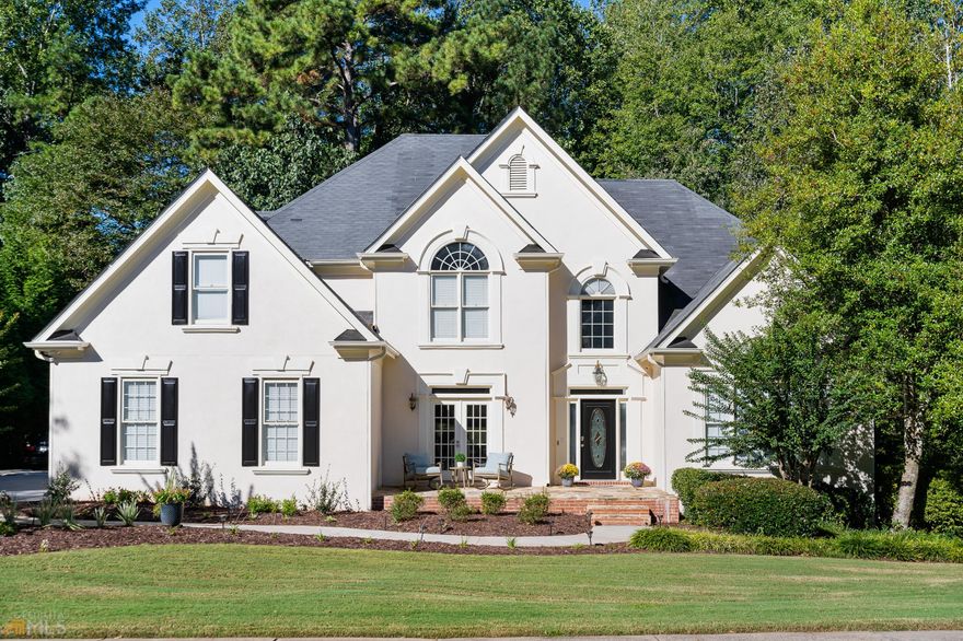 Beautiful newly updated home in Milton's highly sought gated/golf/swim/tennis community, Crooked Creek. This 4 bedroom 3.5 bathroom home has luxury finishes featuring modern, high-end details throughout. Key features include master on main, newly renovated kitchen and master bathroom, hardwoods throughout, unfinished basement and large private yard. As you step inside the two-story foyer, you're greeted with an abundance of natural light and an open floor plan. Your eyes will go straight to the sleek marble fireplace and modern staircase. The updated kitchen is a dream featuring quartz countertops, new cabinets, a double oven, and SS appliances. Cozy up in the sunroom off the kitchen, or relax on the back deck overlooking all the nature. End the day in the master suite and recently renovated master bath, marble throughout and amazing oversized closet! The upper level features 3 additional spacious bedrooms and 2 full baths. The unfinished basement offers endless possibilities. Zoned for Top rated schools, minutes from GA 400, and unbeatable neighborhood amenities - 11 tennis courts, waterpark pool, and social events for everyone.
