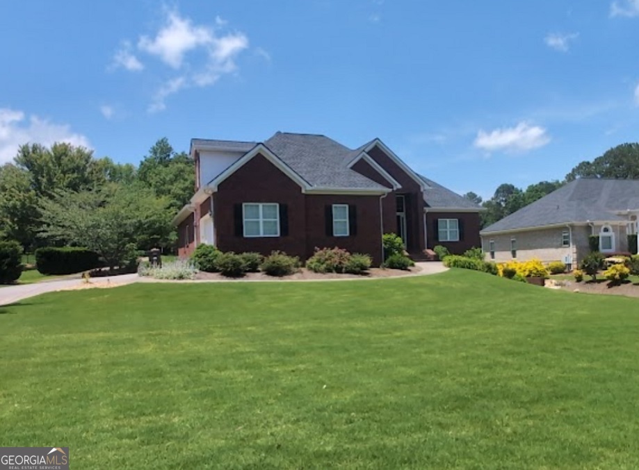 Charming Ranch in Sought-After Championship Oak Mountain Golf subdivision! Welcome to 103 Champion Drive, a beautiful ranch-style home nestled in a quiet, established neighborhood. And even better it overlooks the green on the 8th hole. This inviting residence features 5 spacious bedrooms and 4 full bathrooms, offering a comfortable and functional layout perfect for entertaining. Step inside to discover an open-concept living and dining area filled with natural light, a cozy fireplace, and hardwood flooring throughout. The kitchen boasts ample cabinet space, updated appliances, and a convenient breakfast nook-ideal for casual dining. The owner's suite includes an en-suite bath with vaulted ceilings, generous closet space, and tray ceilings. Four additional bedrooms provide flexibility for family, guests, home office, or hobbies. Outside, enjoy your level backyard, perfect for outdoor entertaining, gardening, or simply relaxing. The fully finished basement offers incredible versatility, featuring a private bedroom, two spacious living areas, a dedicated office or potential sixth bedroom, a full bathroom, and a second kitchen - ideal for guests and in-laws. This home also includes a two-car garage on the main level plus an additional garage in the basement. Recent updates include a new roof, water heater, and dishwasher - all completed in 2023. Conveniently located just minutes from downtown Carrollton, schools, shopping, restaurants, and the University of West Georgia. This move-in ready home combines comfort, location, and value - don't miss this fantastic opportunity!