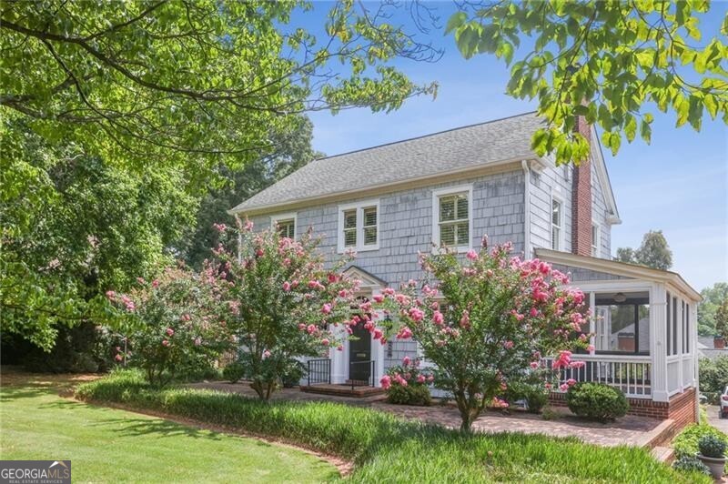 Historic Marietta Gem with Timeless Character and an Exceptional Location Welcome to the Blair-Wright-Johnson House - a beautifully preserved 1923 Cape Cod nestled along iconic Cherokee Street. Lovingly maintained by the same family for over 50 years, this rare property offers a remarkable blend of architectural legacy, enduring craftsmanship, and walkable convenience. Built by Judge D.W. Blair for his newlywed daughter and the birthplace of Charles Bagley Wright, visionary developer of Seattle's Space Needle, this home is steeped in narrative and pedigree. Original oak floors, cedar shake siding, a hand-carved entry surround, millwork, and two period fireplaces speak to the attention to detail and artistry of its era. Thoughtful updates throughout have preserved the home's historic charm while enhancing everyday livability-making it truly move-in ready for modern life. Set on a generous half-acre lot, the grounds are lush and private, featuring mature landscaping that boasts majestic grand magnolias, a brick patio, and a Cherokee stone dining terrace-ideal for morning coffee, intimate dinners, or outdoor entertaining. There's also ample space for future expansion or a guest cottage. Located just minutes from I-75/575, Wellstar Kennestone Hospital, and leading medical campuses, this home offers quick access to professional hubs while remaining a serene retreat at day's end. Stroll to Marietta Square for locally loved boutiques, acclaimed restaurants, live music, a historic movie theater, and the vibrant weekend markets. For outdoor enthusiasts, the Mountain to River (M2R) trail system is just blocks away-connecting you to scenic Kennesaw Mountain National Battlefield Park and offering the perfect setting for walking, running, and biking. This is more than a home-it's a cherished part of Marietta's living history, ready to welcome its next steward.