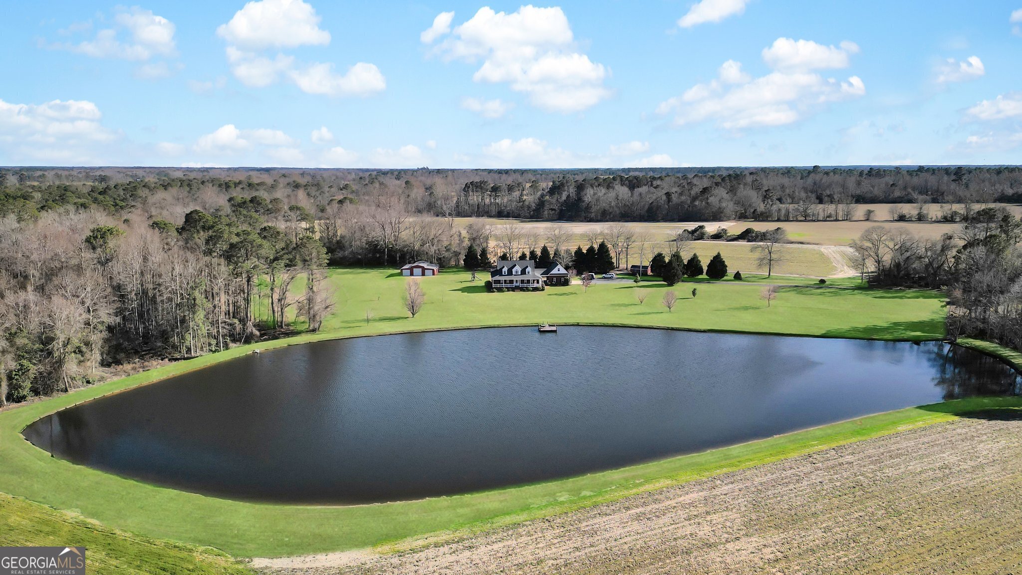This Bulloch County DREAM PROPERTY boasts a custom built home, over 20 acres of land, large and deep stocked pond, 3 bay 42x40 metal storage building with spray foam insulation and 18x20 metal pump house/storage building! This home has privacy and some of the most beautiful scenery in the county!! The home features 4 bedrooms, 3.5 bathrooms, a semi-open concept, 3/4 inch nail down hardwood floors and so much more! The property is currently divided into 3 tracts, so you would have the luxury of selling the additional lots or building a home for your family or friends! The back deck and dock are composite boards for long lasting durability! Additional features include 2x12 treated floor joists, wood pellet fire stove, the long asphalt driveway was repaved in 2017, under ground sprinkler system, outside electric outlet for generator hook up, there is a 20x20 loft in the storage building, 1200 sq/ft covered front porch, 250 gallon water tank and 80 gallon water heater. This home was built to last!!!
