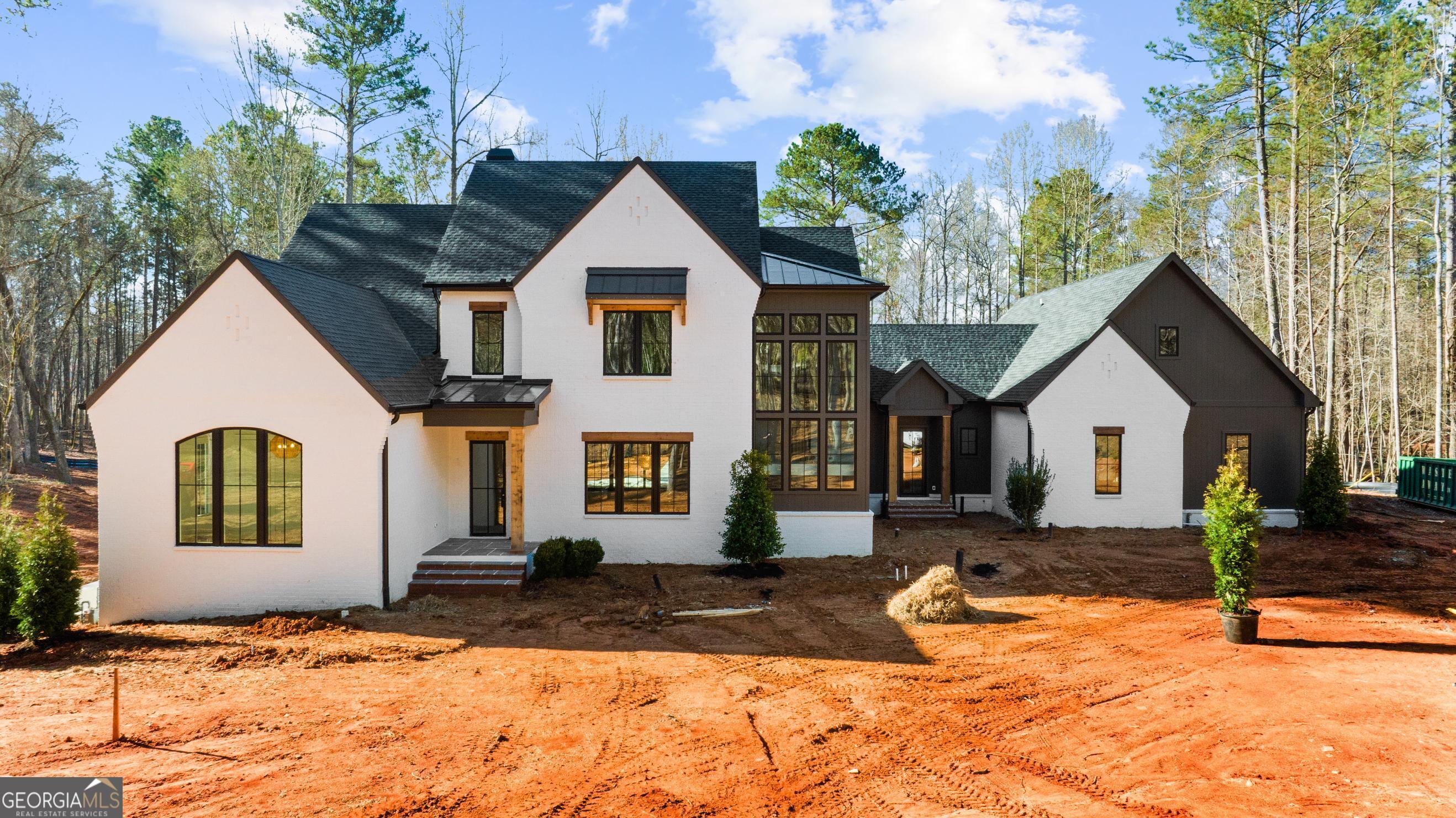 Gorgeous new construction built by Jason Hipps Homes! Perfectly situated on 4.6 acres in Cherokee County with Alpharetta address. Timeless open floor plan concept featuring 5br 5.5ba, owners suite on main with spa like bathroom, frameless glass shower, separate soaking tub, custom his and hers walk in closet. Designer kitchen with top of the line Thermador appliances, oversized island, quartz countertops, custom inset cabinetry, separate vaulted breakfast room and walk in pantry! Family room overflowing with natural light, rustic beam ceilings and brick fireplace. Expansive 16x10 California sliding glass doors leading out to the covered outdoor living area with fireplace, tongue and groove ceilings with Sonos speakers, drop brick flooring all overlooking 16x32 heated saltwater pebble tec pool with raised spa. Wide plank white oak hardwood floors throughout! Secondary level features 4 bedrooms 4 full bathrooms, loft/media room, huge bonus room over 4 car garage and ample storage space! Terrace level awaiting your finishes, can accommodate additional bedroom, wine cellar, bar, billiard room and home gym! Will be completed in 45 days just in time for Spring/Summer!