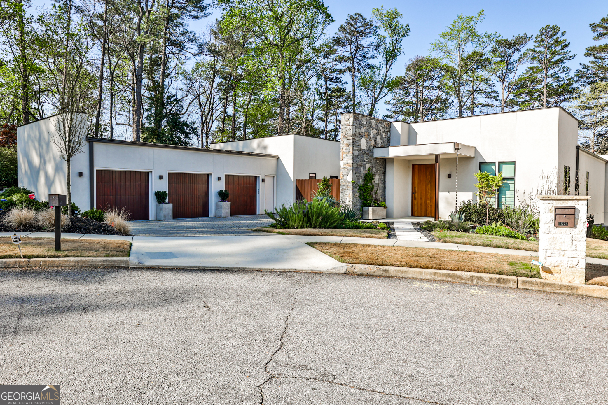 Welcome to this stunning contemporary gem, one of only 5 homes located in this exclusive enclave. The inviting foyer opens to an expansive, light filled living space with high ceilings, gallery walls, wide oak floors and dining for 12---the perfect setting for entertaining Co-and a full wall of luxury glass doors opens completely, showcasing a plant-filled patio with gorgeous saltwater pool and breathtaking views of the 14th hole of the Druid Hills Golf Course. To open custom window treatments, turn on designer lighting or listen to music, simply ask Josh ai, the ultimate in-home automation system, to do it for you! The kitchen, overlooking a private garden, is a true chefCOs paradise w large center work island, top of the line Gaggenau appliances, sub- zero refrigerator, freezer and wine fridge, induction stovetop, 2 ovens, 2 dishwashers, built in coffee machine, walls and walls of custom cabinetry and a scullery with an additional sink and fridge. A 3-car garage leads to a step- less, informal foyer, perfect for coats and shoes, a large laundry room, and the powder room. The right wing of the home features the private, primary suite, with stunning golf course views and pool access and an ensuite bath featuring a steam shower, tub, double sinks and seamless cabinetry. An enormous walk-in closet completes the suite. The relaxing den features comfortable seating areas and state of the art media equipment and a ChiddenC separate home office completes the right wing. The left wing contains 3 well-proportioned secondary bedrooms, each with its own ensuite bath and ample closets. The lower level, with high ceilings and space galore, is the perfect place to playCo with an enormous game/recreation room, soundproofed music room, sun-filled home gym with 2-person sauna, studio- sized in- law or au pair suite with its own separate entrance and plenty of unfinished space for storage or additional rooms. An enhanced state-of-the art security system, A Halo whole house water system and a generator are just a few of the extra enhancements in this one-of-a-kind home in historic Druid Hills.