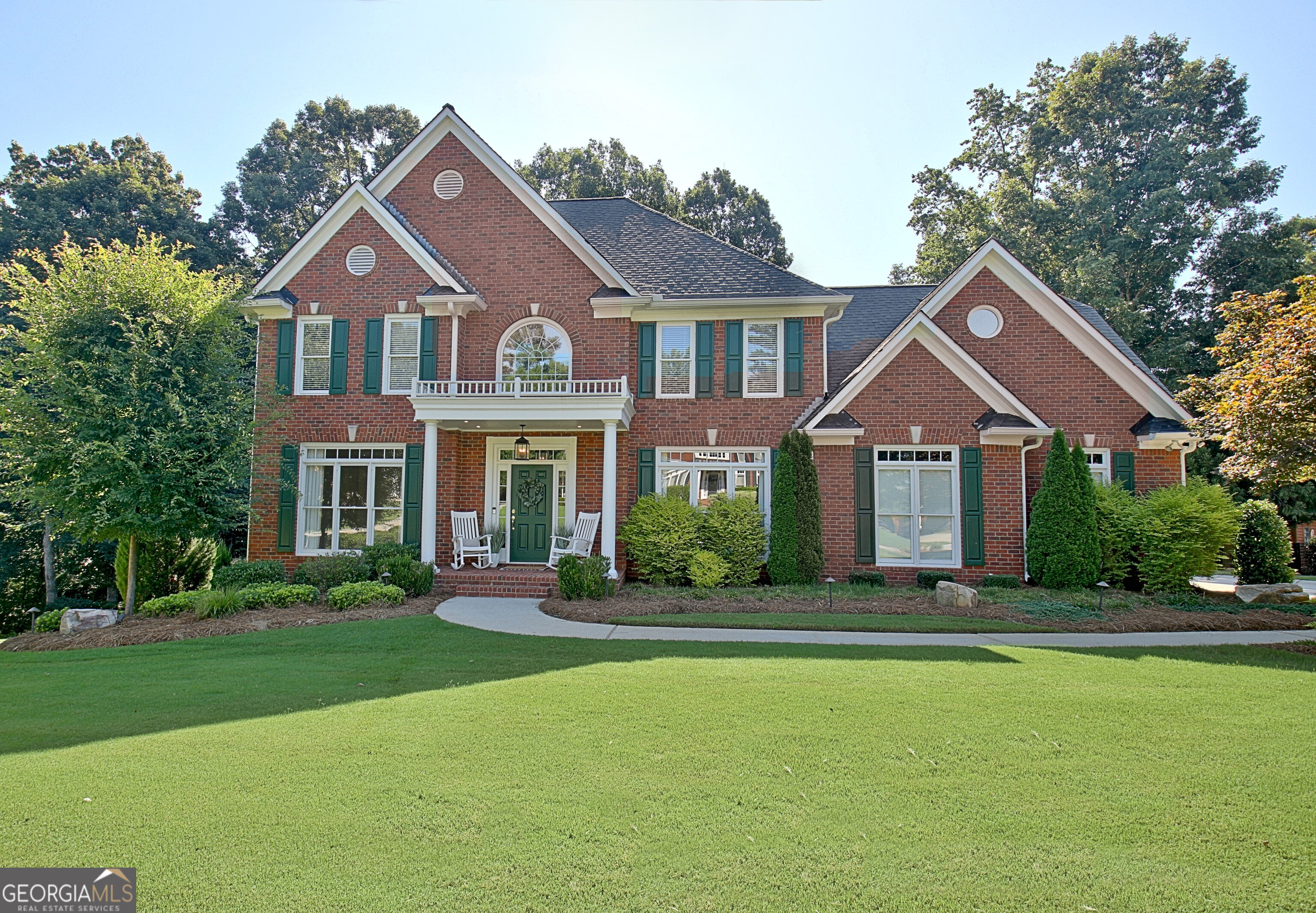 WELCOME TO THIS METICULOUSLY MAINTAINED EXECUTIVE HOME WITH LUXURY FINISHES & AN OUTDOOR OASIS in The Heritage, one of Peachtree City's most coveted communities! This exquisite two story, three sided brick home with finished terrace level perfectly blends timeless elegance with modern convenience, offering a total of five bedrooms, 3 full baths and 2 half baths - all just minutes from Kedron Village Shopping Center's boutique shops, restaurants, and top-rated schools. Step inside to beautiful hardwood flooring on the main level, where a formal sitting room / office and separate dining room create a sophisticated entrance. The heart of the home is the spacious family room, featuring a charming brick fireplace, built-in bookshelves, and an open flow into the updated kitchen. Enjoy cooking with a 5-burner gas cooktop, granite countertops, wall oven/microwave combination and a walk-in pantry. Fresh white cabinetry, under cabinet and above cabinet lighting, and a vaulted breakfast room add warmth and functionality. Just off the kitchen, a magnificent vaulted screened-in porch with spiral stairs overlooks the private backyard oasis. Upstairs, the luxurious primary suite boasts His and Hers closets and a spa like ensuite with custom tile shower and freestanding tub. Two additional bedrooms share a hallway bath with dual vanities, a porcelain tub and tile surround, while a large bonus room offers flexibility as a fourth bedroom. Front and rear staircases provide convenient access throughout the home. The finished terrace level is an entertainer's dream or the perfect in-law suite, featuring a family room, kitchenette (with fridge, dishwasher, ice maker and granite countertops), bedroom with large closets and ensuite bath, additional powder room, secondary laundry room, ample storage, and private access to backyard. A dry-below decking system ensures year round enjoyment. Step outside to a stunning backyard retreat, complete with Silver Travertine pavers, large saltwater spa, a beautifully designed sunken firepit, lovely landscape lighting throughout, custom stone walls and walkways and perfectly tailored landscaping. Additional upgrades include new water heater, newer HVAC, mini-split in bonus room, all new Hardiboard soffits, new gutters and fresh exterior paint (2024). A two car garage with overhead storage bins and an electric hoist system rounds out this exceptional home. Located on the desirable North side of Peachtree City, The Heritage offers easy access to golf cart paths, shopping, dining, recreation, golf/tennis/pickleball, and all the schools - giving you the best of both convenience and luxury.