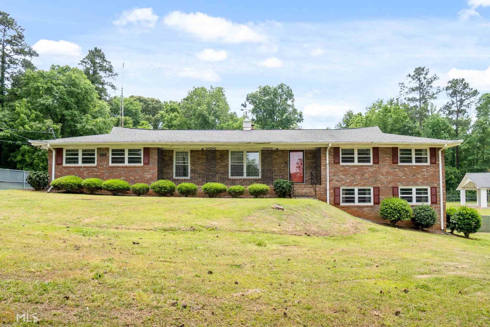 Looking for a workshop, RV Parking, and an outdoor entertainment area? This is it! Well maintained home in an established community on 1.7+/- acres featuring 3 outbuildings! One of the outbuildings/pavilion is large enough for an RV and also features a half bath and kitchen that is perfect hosting a family reunion or large gathering. Inside your will find beautiful (original) hardwood floors, a sunroom, large family room, formal living and dining room, and a spacious kitchen with granite countertops. Downstairs are 2 additional bedrooms and a large rec room complete with a wet bar! This home is located in a very quiet Lake Community. Don't miss it!