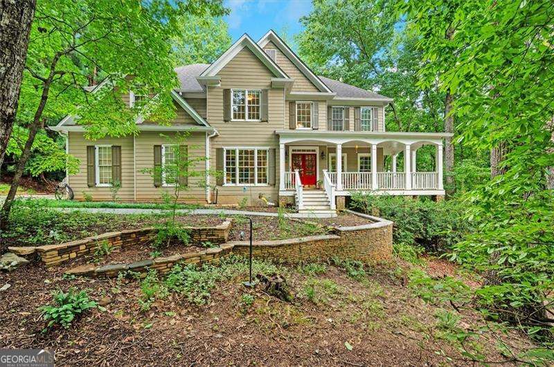 Welcome Home to Four-Season Living at Its Finest! This beautifully designed finished basement executive home is nestled deep on a spectacular 1.34-acre private lot on a quiet cul-de-sac street in Grove Park - a premier amenity-rich community known for its endless beauty, green space and ideal location minutes to everything, but seemingly miles away from it all! This wonderful home offers a fabulous open floor plan, comfort, charm, and entertainment-ready features make everyday living feel like a retreat. You'll experience scenic views and an abundance of outdoor living amenities beginning with the long and level tree-lined driveway, fragrant herb garden and wonderful wraparound rocking-chair front porch. Exceptional living spaces are standard features in this home. Step inside the welcoming two-story foyer while noticing the stunning hardwood flooring and triple crown moldings throughout the home. The foyer is flanked by a spacious main-level bedroom with private bath access and a living room/office space with large windows and scenic views. The heart of this lovely home includes a banquet-sized dining room and a large, bright, inviting chef's kitchen perfectly blending style and function with a gas range, endless granite counter-tops and cabinetry with soft close drawers, a large breakfast area and bar, pantry and so much more. The kitchen is open to a magnificent family room with soaring ceilings and a two-story stacked stone, gas or wood-burning fireplace, and backstairs to the 2nd-floor! You'll fall in love with the adjoining sunroom offering stunning panoramic views of nature connecting you with the outdoors year-round. Upstairs, the owner's suite is a true retreat with a relaxing sitting area, more great views, beautiful hardwood floors, natural stone finishes, a walk-in shower, Jacuzzi tub, and a large closet. You'll also find roomy secondary bedrooms, a jack-and-jill bath and an upstairs laundry room on this level of the home. The finished terrace level is purpose-built for fun and function - perfect for game night, guests and multigenerational living. It includes a pool table, party kitchen, family/media room with gas log fireplace, bedroom/office, full bathroom, craft/hobby room, ample storage and a stone patio leading to an amazing backyard oasis including upper and lower decks perfect for grilling and gatherings, a brick patio with built-in benches ready for a cozy fire pit night, a built-in 6-person hot tub beneath a charming pergola, a sodded grassy area for recreation, a butterfly garden and a spring-fed creek - all with an incredible connection to the surrounding sights and sounds of nature. This home adapts to your lifestyle-whether entertaining, relaxing, or working from home-and offers beauty in every season. Welcome Home!