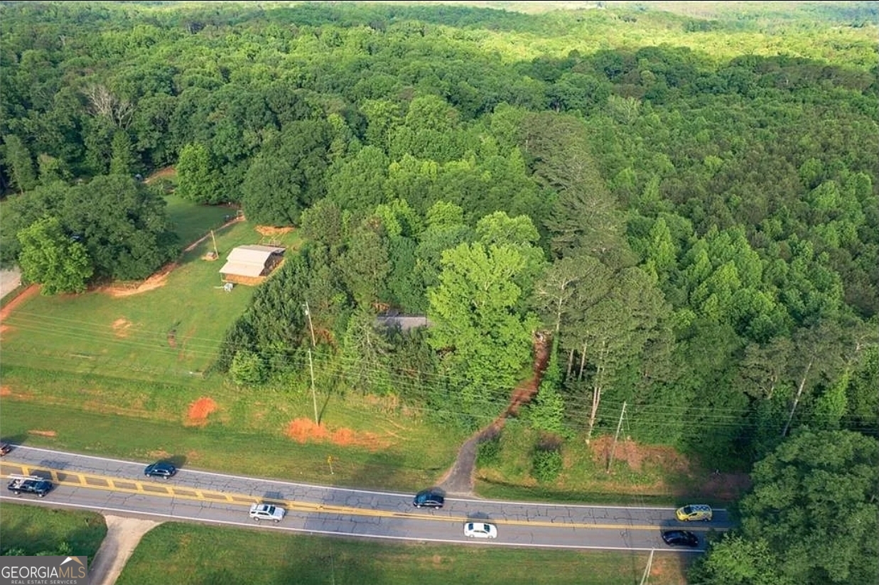 PRIME LOCATION! Potential Commercial Location with many Commercial Buildings close by and has been verified by County Commissioners. 210 Feet of Road Frontage on Hickory Flat Highway. +/- 18,000 Daily Traffic Count. Convenient to both Highway 575, Hwy 20, and Northside Hospital Cherokee. Home on the property will need to be torn down.