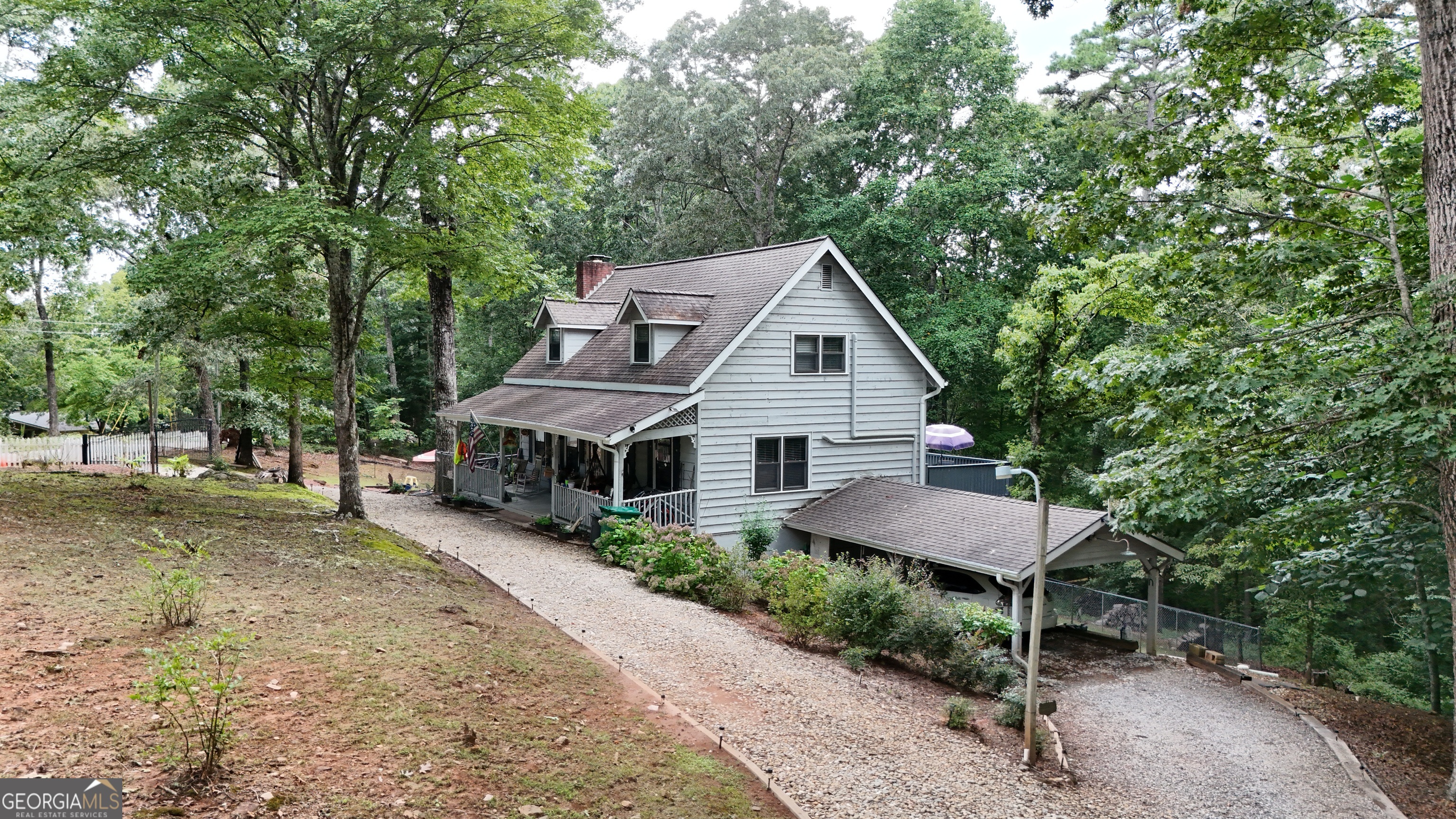 Charming Cabin-Style Home on Over 2 Acres in the North GA Mountains! Nestled in a highly sought-after location just off Cannon Bridge Rd, this beautiful cabin-style home offers the perfect blend of mountain charm, privacy, and modern comfort-with no HOA fees and situated in a welcoming community. Enjoy over 2 private, gated acres with a fenced backyard-ideal for kids or furry friends-and a circular driveway with ample parking, including dedicated RV parking with a 30-amp hookup. Step inside to find hardwood floors throughout, a cozy wood-burning fireplace in the living room, and a bright, open dining area. Just off the kitchen is an additional flex/storage space, perfect for a pantry! The main-level master suite includes a cozy bedroom and a relaxing soaking tub in the ensuite bath. Upstairs, you'll find two oversized bedrooms and a beautifully updated full bath with a custom tiled, standalone shower. Downstairs, a finished bonus room offers great potential as an office, gym, or extra sleeping space, along with an oversized laundry room and one-car garage. The garage connects to a covered carport, offering added convenience on rainy or hot sunny days. Outdoor living easy here: Rocking chair front porch, Large back deck spanning the length of the home - perfect for morning coffee or evening gatherings, Covered lower deck with room for storage or a relaxing porch swing Fire pit area for entertaining under the stars, Utility building for even more storage. This property has a spring head with a hand pump! Don't miss this opportunity to own your private mountain getaway, conveniently located and packed with charm! ** An additional 1-acre lot is also available-ideal for expanding your mountain retreat.
