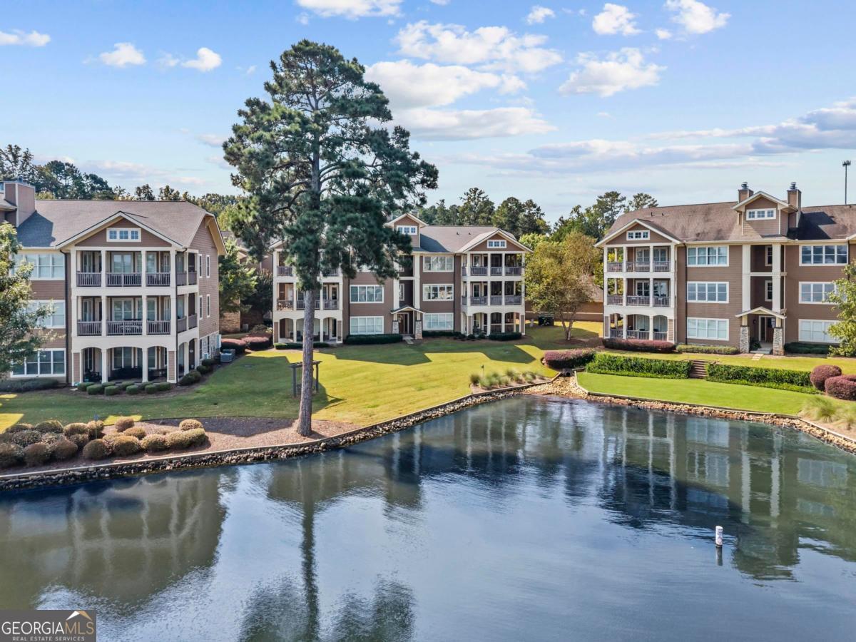 Lakefront Living at Its Best - Waterfront at Lake Oconee Discover effortless lakefront living in this beautifully updated 3-bedroom, 2-bath condo in the conveniently located Waterfront at Lake Oconee community. Just steps from the lake and community docks, this "lock and leave" unit offers the perfect blend of convenience and relaxation. Enjoy stunning big water views and peaceful mornings on a quiet cove from your screened-in porch. Take a short stroll to the community pool and clubhouse. The interior features updated flooring and lighting throughout unit; an updated kitchen with quartz countertops, LG appliances and new backsplash; shiplap details, whole home water filter and a brand new water heater. The open-concept layout is ideal for entertaining or quiet evenings in front of the wood burning fireplace. The condo includes a one-car garage - perfect for storing your lake toys and gear - provides easy access to all the recreation Lake Oconee has to offer. You can also store your own boat, rent one for an afternoon or join the boat club all at the marina just steps away. Whether you're looking for a weekend getaway or full-time lakefront lifestyle, this condo has it all.