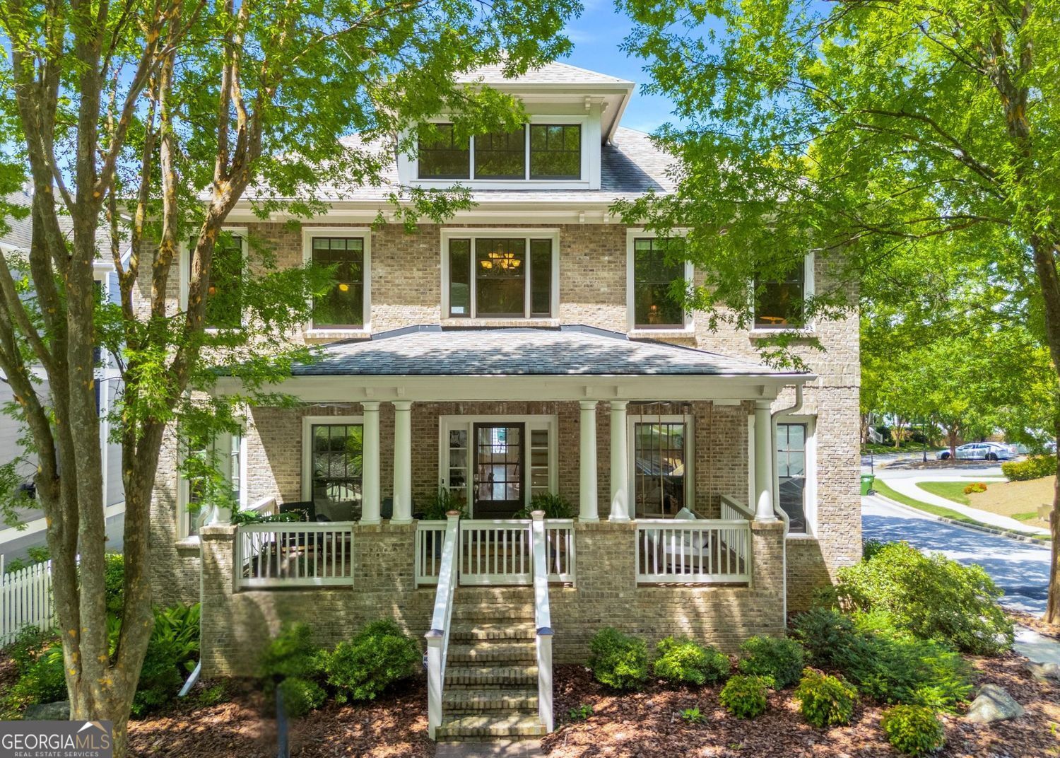 Welcome to this stunning, one-of-a-kind home in highly sought-after Dupont Commons, featuring the largest floorplan in the neighborhood and a rare 3-car garage. From the moment you step onto the picturesque covered front porch, you'll be captivated by the charm, space, and thoughtful design throughout. Enjoy hardwood floors throughout the entire home and an abundance of natural light that fills every room. The open concept main level is an entertainer's dream, boasting a chef's kitchen with sleek updates, a mini wet bar, and seamless flow to the back deck - perfect for grilling and enjoying beautiful weather. The kitchen opens into a spacious family room with custom built-ins, creating a warm and inviting central hub. Two additional flexible living spaces on the main level offer options for a formal dining room, home office, playroom, or extra lounge areas. Upstairs, enjoy three full bathrooms, and generously sized bedrooms. The luxurious primary suite is a true retreat, featuring an extra-large walk-in closet and a beautifully appointed en-suite bath. The oversized basement provides even more living space with a private guest room, abundant storage, and endless options for recreation - imagine a ping pong room, teen hangout, home workshop, and still space to park three cars! Prime location directly across from green spaces, the neighborhood pool, and gym. Don't miss your chance to own this exceptional home with unmatched space, versatility, and charm in Dupont Commons.