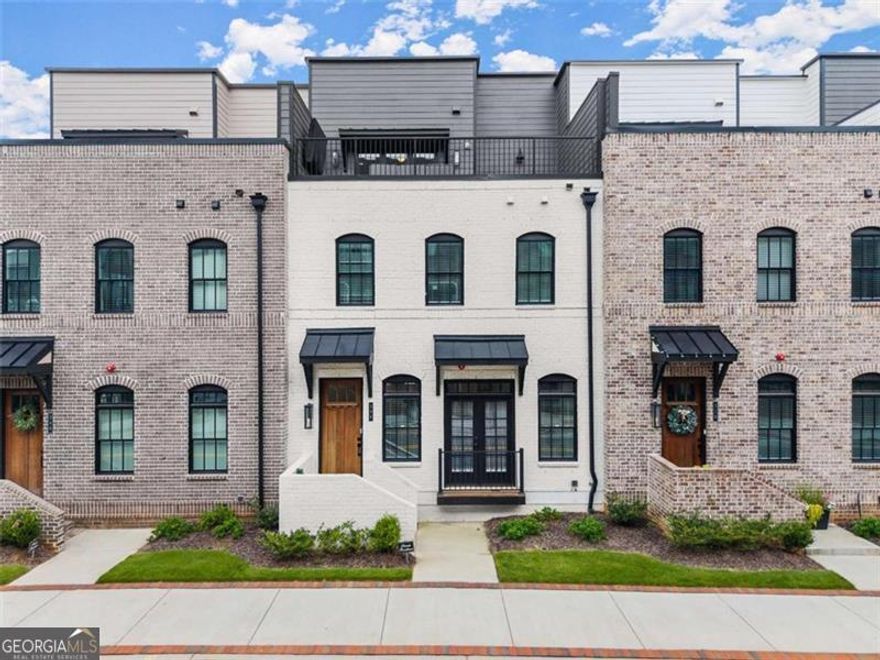 Is there a 4-bed townhome in Downtown Sugar Hill with a rooftop terrace and lease-to-own flexibility? Yes and it just dropped $75K. This four-story luxury townhome is packed with value, style, and walkability just steps from The Bowl, Eagle Theatre, and the Sugar Hill Greenway.  Lease-to-purchase opportunity available move in now, buy later! Ideal for buyers building credit, preparing for financing, or needing flexibility. Now priced $75,000 below market, this townhome offers premium finishes and modern convenience in a location that puts you in the heart of Sugar Hill's best amenities.  The open main level features designer lighting, luxury flooring, and a gourmet kitchen with quartz countertops, stainless appliances, custom cabinetry, and a spacious island that opens to a covered balcony. Upstairs, the owner's suite includes a frameless glass shower, dual vanities, and custom closet system. Every bedroom includes a private bath for maximum privacy.  A flexible bonus room with sliding doors opens to a turf-covered balcony perfect as a home office, playroom, or media space. The entry level includes a private guest suite with full bath, ideal for visitors or in-laws. A private elevator connects all four floors.  The rooftop terrace is an entertainer's dream: turf flooring, grilling area, covered TV mount, and panoramic city views.  Special financing available through Jeff Zulauf at Cross Country Mortgage with a 2-1 Rate Buydown starting as low as 4.125% in Year 1 (restrictions apply).  Call or text Cindy LaDuke at 678-650-1425 to schedule a private tour or ask about lease-to-purchase terms.