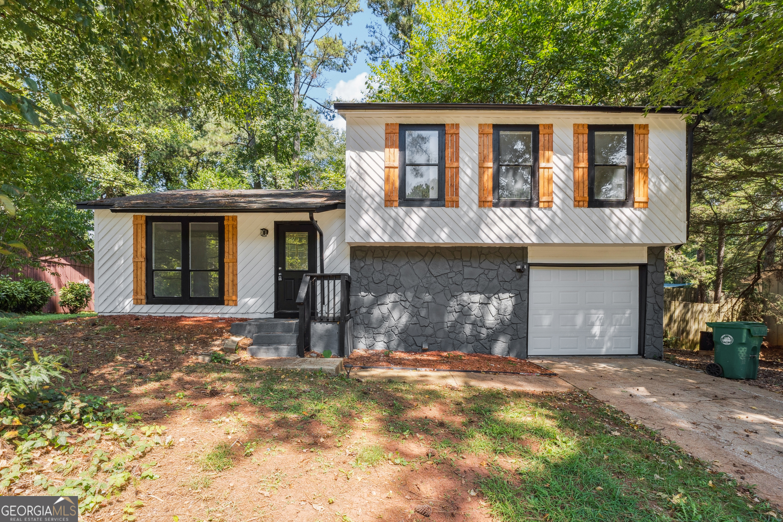 Welcome to this beautifully renovated 3-bedroom, 2-bathroom home located in the heart of Stone Mountain. This property offers a spacious floor plan with fresh updates throughout. The kitchen has been completely renovated with modern finishes and ample cabinetry, flowing seamlessly into the dining and living areas for easy everyday living and entertaining. Both bathrooms have been updated, and the home features new flooring and fresh paint, creating a clean and inviting atmosphere. Each bedroom is generously sized to provide comfort and privacy. Outside, a private backyard offers the perfect space for relaxation or gatherings. Conveniently situated near shopping, dining, schools, and major highways, this home combines comfort with accessibility. Schedule your showing today before it's gone!