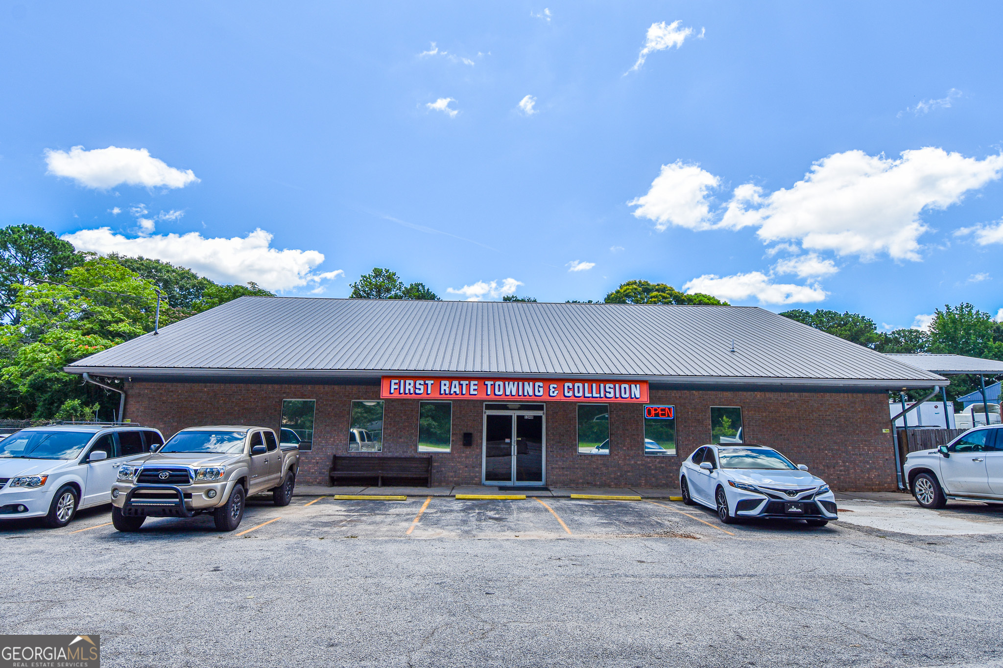 Here is your chance to own the perfect setting for your automotive business! Located along one of Griffin's busiest roads and currently used by an established towing and collision company, this commercial space will afford you ample space to get right to work with two offices, large garage and a secure gated lot for vehicle storage. Included with the property are two car lifts, paint booth, air compressor, garage heater and metal car shed. You can concentrate on work knowing the roof is newer and the septic system was serviced less than a year ago. The business operating here currently may be purchased in addition to the physical property. More information is available upon request. Thank you for your interest!
