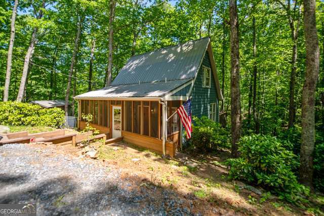 AS-IS MOTIVATED SELLER***Quaint 1 bedroom/1 bath on 1.79 acres with new flooring in great room, open kitchen to great room, back deck with hot tub, utility area, screened front porch, fire pit, private setting, private well, close to Carters Lake and boat ramp. GREAT RENTAL, PART TIM OR FULL TIME LIVING.