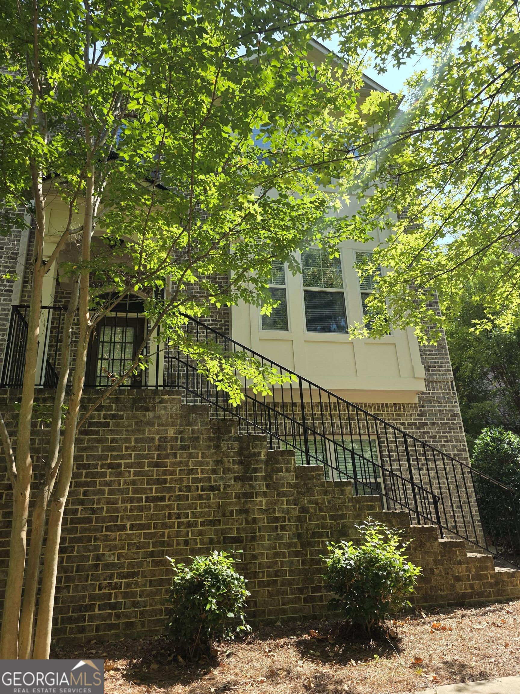 This beautifully designed FOUR-bedroom, Three and a Half-bathroom townhome offers the perfect blend of style, comfort, and functionality. The open-concept main level is made for entertaining, featuring a bright gathering room that flows into a chef's kitchen with quartz countertops, an oversized island, commercial-grade stainless steel appliances, a stylish tile backsplash, and a walk-in pantry. Upstairs, the owner's suite is a true retreat, boasting tray ceilings, large windows, and a spa-inspired en-suite bath with dual vanities, an oversized frameless glass shower, and a spacious walk-in closet. A secondary upstairs bedroom includes its own en-suite bath and walk-in closet, offering comfort and privacy. The fully finished terrace level adds versatility, featuring a fourth bedroom with a full bath, perfect as a guest suite, home office, or media room. Additional upgrades include custom built-ins, designer lighting, smart home technology, and hardwood floors throughout the main level. A two-car rear-entry garage and energy-efficient features make this home as practical as it is beautiful. Move-in ready and designed to impress! ALL THAT PLUS, the gated community is located a stone throw from major highways and includes walking trails, playground, pool & clubhouse complete with a gym and plenty of parking for guests!