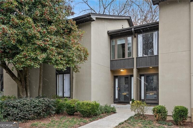 Amazing 3 bedroom in prime Buckhead location! This spacious townhome has been renovated and refreshed and is move in ready. The kitchen has been updated including white cabinets with new quartzite countertops, subway tile backsplash, new hardware, new stainless steel appliances and a separate dining area with seating for 6-8 people that opens up to the spacious family room and deck overlooking a wooded and private backyard. All bathrooms have been updated with new vanities, countertops. Upstairs you will find the primary bedroom and secondary bedrooms and bath. The primary bath has a frameless glass shower with rain shower head, new countertops, subway tile shower and new tile floors and it has a generous walk-in closet. On the terrace level you will find an additional secondary bedroom with full bathroom that has been updated and a spacious laundry room with barn door and access to the lower level deck. This home is so conveniently located and you walk to Chastain Park, Hals, Cava, The Chastain. This active community offers a swimming pool, recently refinished tennis courts and a green space area. Come view and make this your home today!