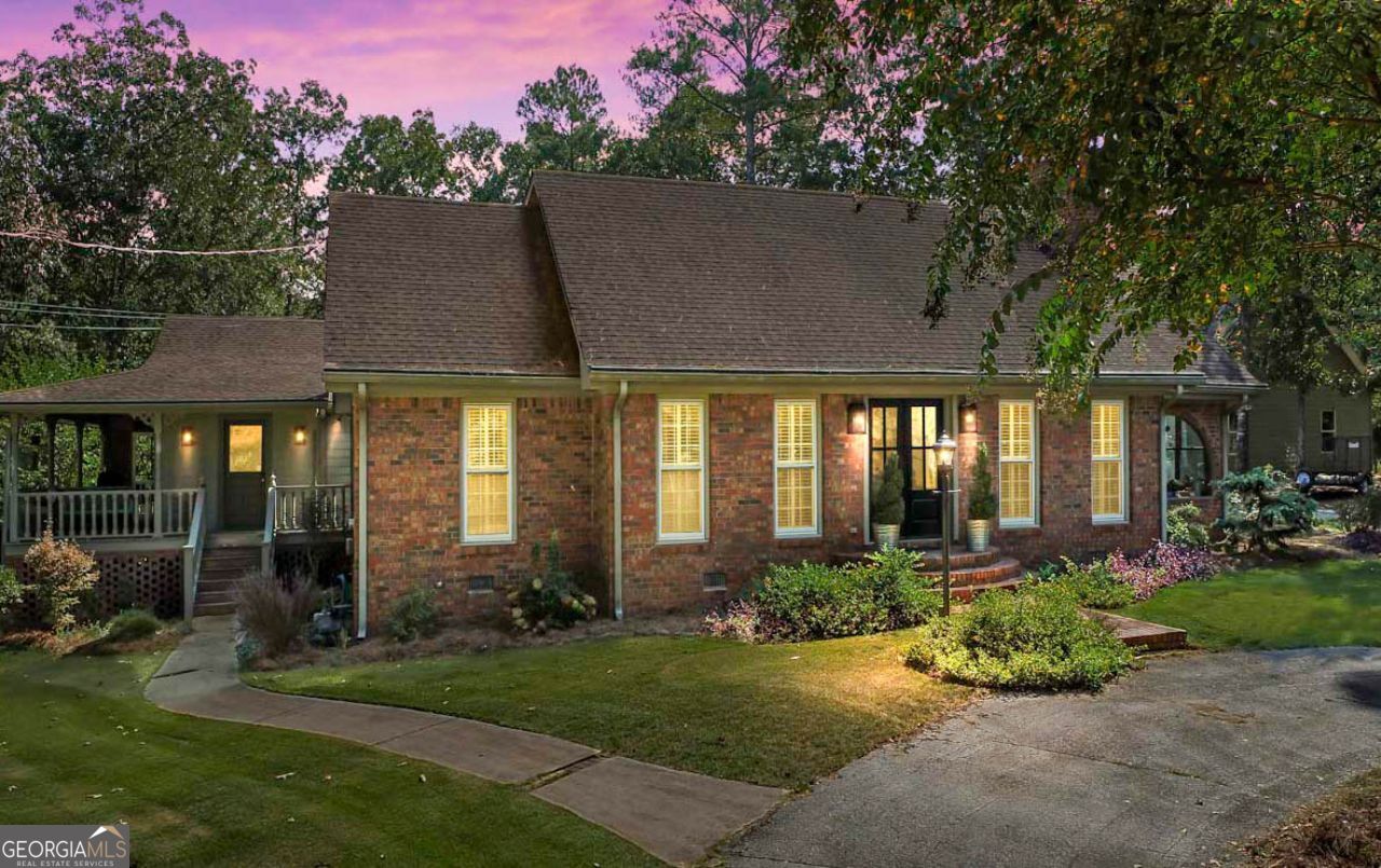 Welcome to your dream home! This beautiful 3 bedroom, 3 1/2 bath home in the sought-after Ola area offers more than can be seen at first glance. From the circular driveway to the inground pool w/ jacuzzi and everything in between, this home offers comfortable living and the convenience of in-town amenities with peaceful private surroundings. As you step into the two-story foyer, you find a spacious living room with a cozy fireplace and a fabulous kitchen with granite counters, stainless steel appliances, and tons of cabinets for loads of storage. And don't forget the fireplace in the large dining area! Beyond the dining area, you'll find a massive family room, perfect for entertaining, with a wet bar, ice maker, and beverage fridge. Off of the living room is a lovely sunroom with an incredible arched window overlooking the front yard. The master suite on the main floor offers luxurious comfort with his & hers walk-in closets with a shared shelf/drawer system between the two. The recently renovated master bath boasts a soaking tub and separate glass shower, dual sink vanity, and tile floors. Upstairs, you'll find two enormous bedrooms, each with its own full bath with tiled showers and solid-surface counters. As if the interior wasn't enough, outside you'll find a wrap-around porch off of the family room which is screened on one side and covered on the other two sides. In the fenced backyard is a wonderful in-ground pool with a hot tub and a patio. Last, but certainly not least, a separate two-car garage with a second-floor storage room is just steps away from the house. Convenient to shopping, restaurants, and Georgia National Golf Club. Schedule your viewing now!