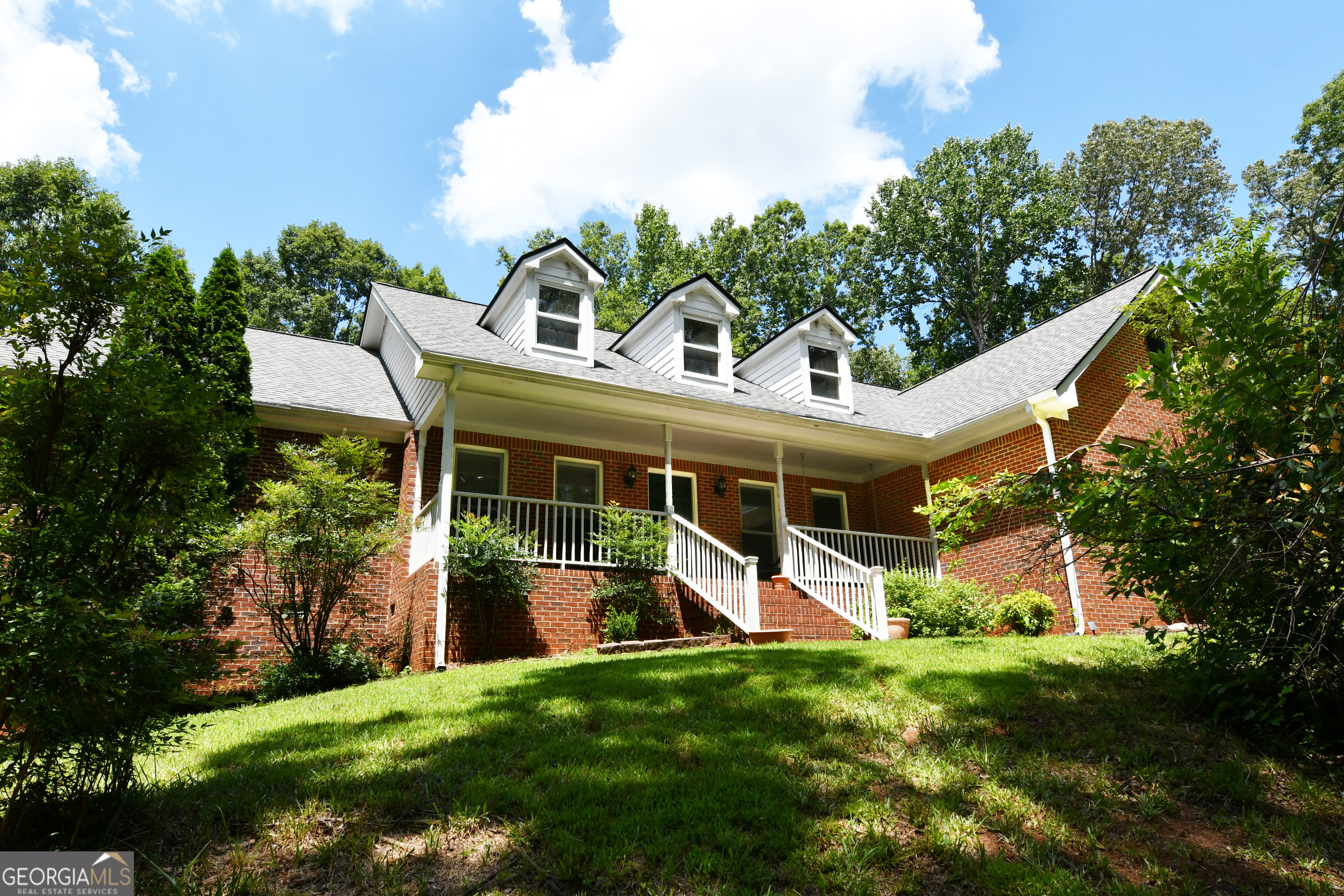Totally private 1.5 acres and no HOA! This beautiful four-sided brick ranch with side entry garage features a long sweeping driveway with loads of extra parking. Rocking chair front porch overlooks wooded front yard for peaceful enjoyment year-round. Interior features foyer, formal dining room, huge family room with fireplace, four season room, breakfast room, hardwood floors, fantastic kitchen with work station, stained cabinets, expansive counter space, gas cooktop, island breakfast bar and large walk-in pantry. Beautiful screened in porch off the breakfast room that overlooks the huge deck, firepit and plush, private fenced back yard. Owner's suite features huge walk-in closet, updated and upgraded bath with soaking tub and tiled shower. Spacious secondary bedrooms with ample closets. Walk up permanent staircase to enormous attic with high ceilings - perfect for additional rooms, tons of storage and flooded with light from dormers. The side door enters into an oversized mud room/laundry room. Your outdoor paradise offers extreme privacy, large open yard perfect for recreation or pool, areas for flower and vegetable gardens, fully fenced and storage shed. Oconee Pointe is a beautiful neighborhood, located just minutes to schools, downtown Commerce, shopping, restaurants and easy access to I-85, Athens and outlet shopping.