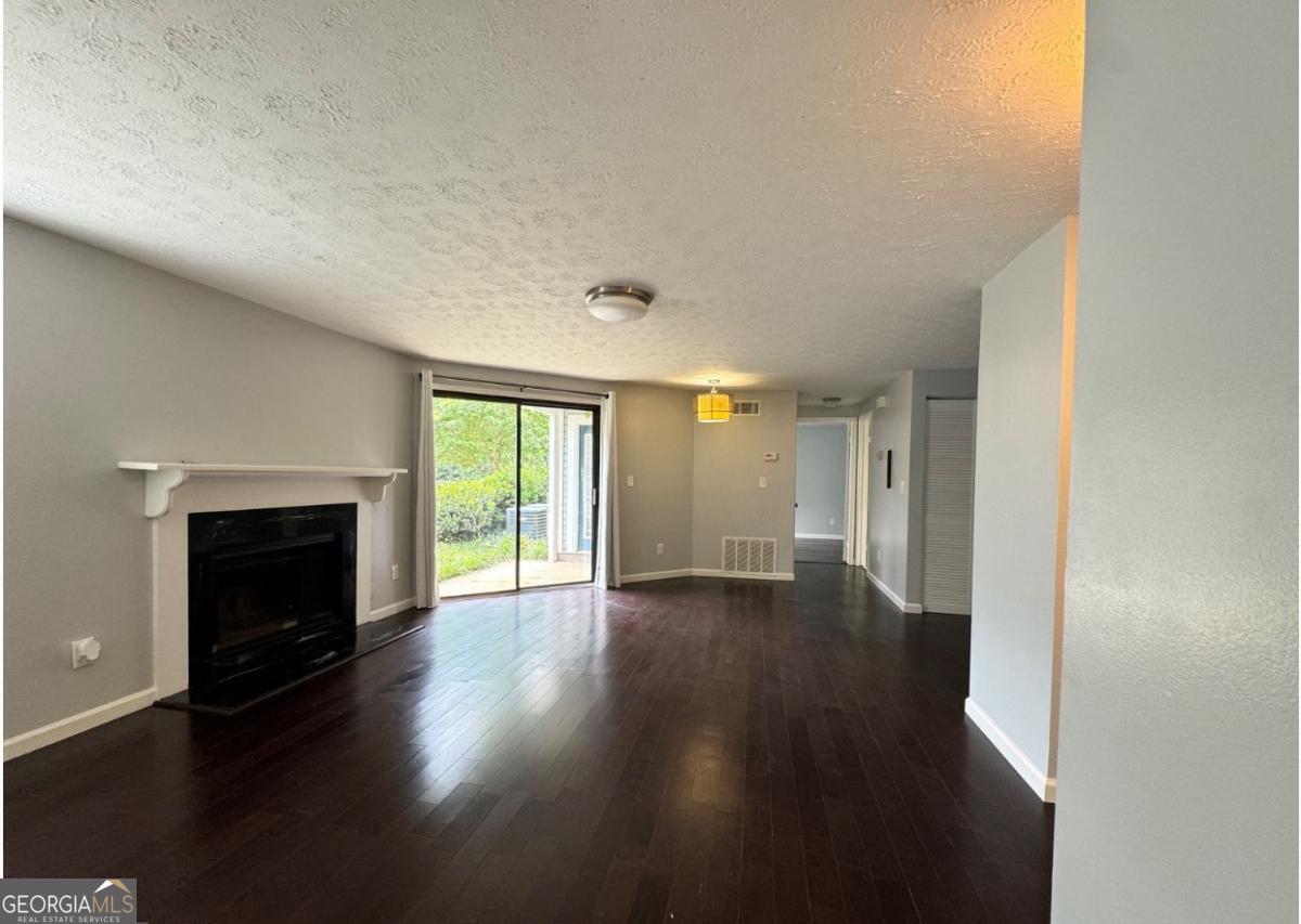 Welcome to this beautifully updated two-bedroom, two-bath condominium nestled in the sought-after Brookhaven area. Designed with both style and functionality in mind, this home boasts an open floor plan filled with natural light, a modern kitchen equipped with stainless steel appliances, and generously sized bedrooms complemented by well-appointed bathrooms. Hardwood floors flow seamlessly throughout the living areas, while the bathrooms feature elegant tile finishes. As a ground-level unit, it offers easy access from the parking lot-perfect for carrying in groceries or shopping bags with ease. The kitchen also includes a spacious pantry with a convenient washer and dryer. Set within the tranquil Keys Lake community, residents enjoy mature landscaping, a peaceful lake, and a prime location just minutes from top dining, shopping, and major highways. This condo is the ideal combination of comfort, convenience, and charm. Don't miss the chance to make it yours-schedule your showing today!
