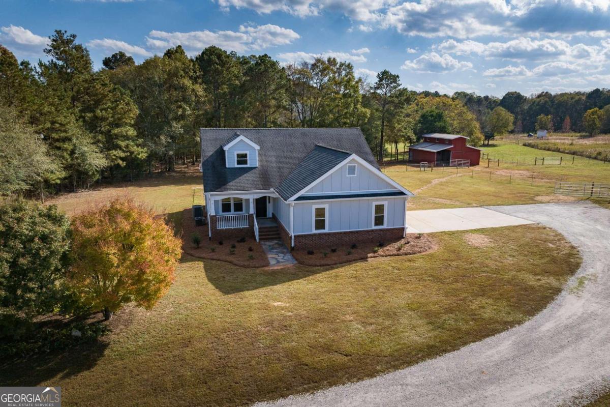 Renovated home on five acres with a 3 stall horse barn with tack room in Oconee County! Fenced and cross fenced with multiple paddocks already established this site is turn key ready. Recently refinished hardwood floors and fresh paint greet you in the two story iving room which also offers an electric (decorative) fireplace and semi open floor plan into the kitchen and dining area. The kitchen has been completely renovated with stainless steel appliances, quartzite countertops, new cabinets, and white subway tile backsplash. A pantry is located under the stairs and a quartzite bartop separates the kitchen from the dining area. Exterior access is available from the kitchen to the large, rear deck. The owners suite is located along the rear of the home and also provides exterior access to the deck. The master bedroom offers hardwood flooring and an oversized walk in closet with luxury vinyl plank, while the ensuite features tile flooring, a tile shower, new cabinets, and dual quartzite countertops. An additional bedroom and bathroom are also located on the main level with fresh updates. Upstairs features a catwalk that overlooks the living room with two bedrooms and a bathroom. Each bedroom offers luxury vinyl flooring while the bathroom features tile flooring and a tile shower. A storage closet is also located at the top of the stairs to maximize the use of the space. The exterior of the home is equally as impressive with fresh paint, an encapsulated crawl space, fencing, and a three stall horse barn with tack room and power! If you have dreams of a mini farm in Oconee County, then look no further!