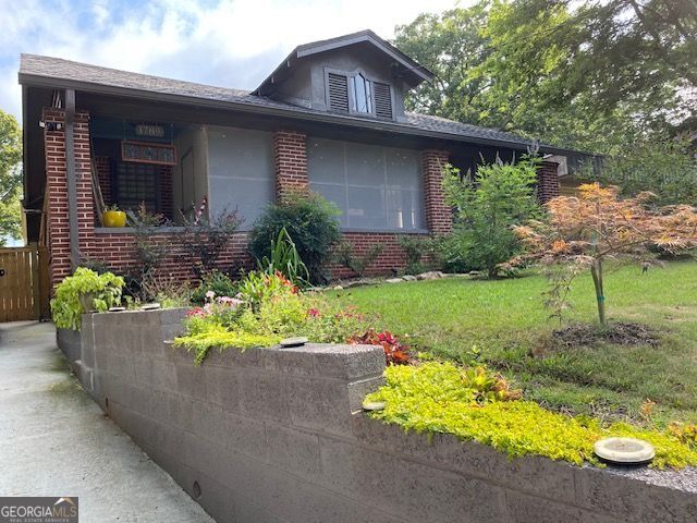 Timeless charm meets modern comfort in this beautifully restored 1930s brick home in Historic Frog Hollow. Oversized rooms, original pecan-stained oak floors, picture molding, and a decorative Craftsman fireplace create a warm, elegant atmosphere. The screened front porch with decorative tile sets the tone, while two-panel wood doors, crystal knobs, and French doors add vintage appeal. The galley kitchen features white shaker cabinets, quartz countertops, stainless appliances, and a walk-in pantry. The primary suite offers a clawfoot tub, marble tile, dual vanities, and a spacious walk-in closet. Outside, enjoy a fenced yard, garden shed, and separate workshop. Walk to MARTA and enjoy quick access to the airport, Midtown, and Downtown. This rare gem blends classic character with convenience in one of Atlanta's beloved historic neighborhoods.