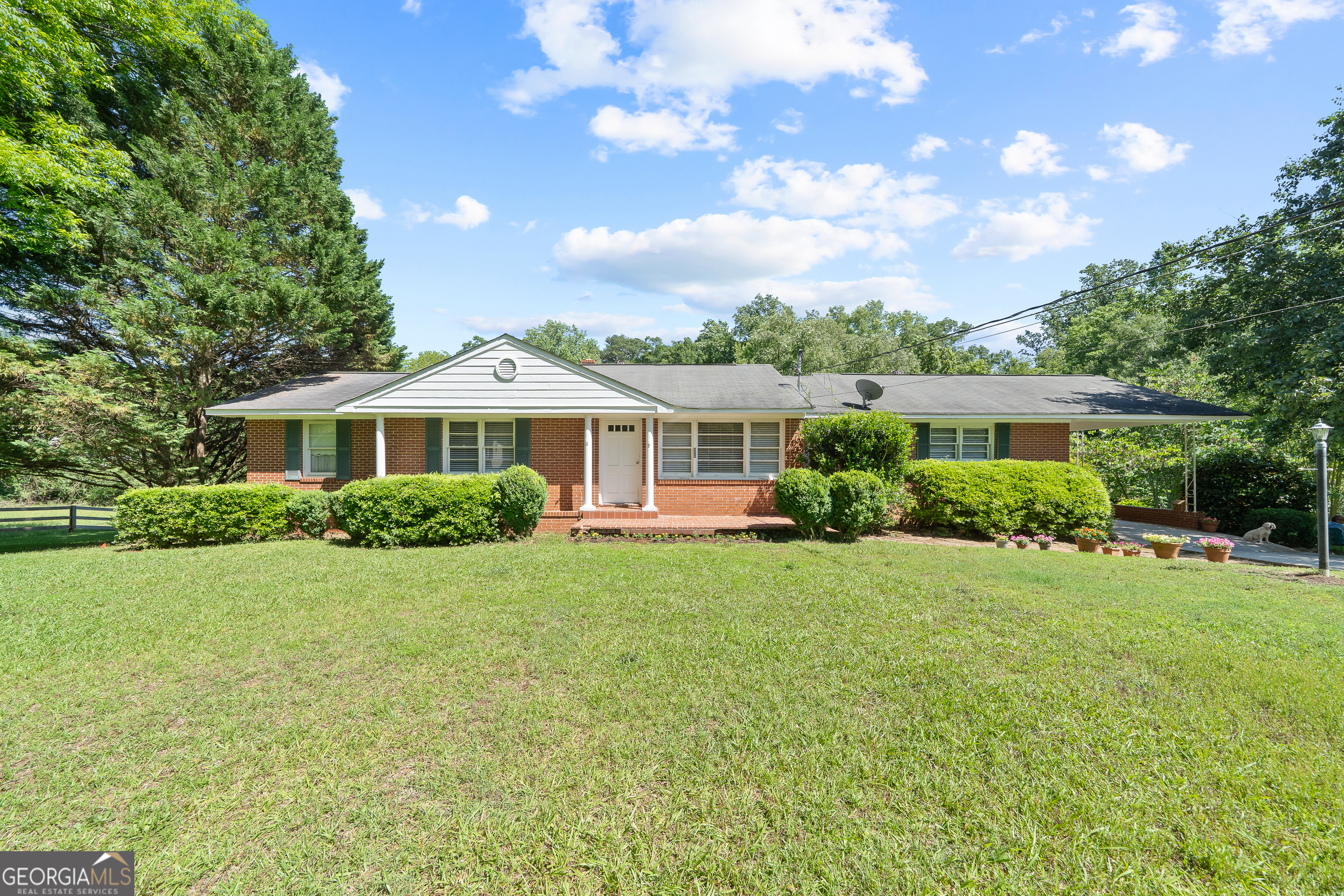 Enjoy peaceful country living in the quaint and storied district of Madison, just a short walk from downtown shops and restaurants. Nestled on a generous 0.82-acre lot, this all-brick, single-level ranch offers a simple, easy lifestyle surrounded by nature's beauty. Backyard includes plenty of space for a gardens and backs up to Horse Branch Creek. The home features 3 bedrooms and 2 full baths tucked on one end for privacy, with the kitchen, laundry room, and living area on the other-providing an ideal layout for everyday living. A window above the kitchen sink overlooks the serene backyard, offering calming views of lush greenery. Step outside to a spacious screened porch and covered back deck, perfect for enjoying morning coffee or evening relaxation in the fresh air. Partial basement with exterior access-great for storage or workshop space Attic access for additional storage potential Beautiful backyard with open views that inspire tranquility Whether you're looking for a full-time residence or a charming getaway, this well-located home combines timeless appeal with everyday comfort. Please note that this property is being subdivided and the house shall be sold with .82 acres retained. Preliminary Plat available. More acreage available. All information deemed reliable, but not guaranteed. Buyer should verify during due diligence.