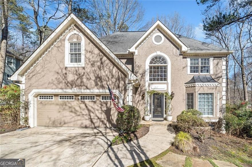 Upgraded Living featuring a Cozy Screened Porch with Woodland Views in Eagle Watch! Serene Views of nature while still being minutes from everything. A zoysia-sodded front yard and a flagstone pathway welcome you to the front door of this Hard-Coat Stucco home. The two-story foyer features a chandelier and grand staircase. To the right, french doors open to a cozy living room that flows into the ship-lapped dining room. Beyond, french doors open to a Screened-in Porch and deck providing the perfect retreat for morning coffee or evening relaxation. The white kitchen features a Palladian window, a gas cooktop, stainless steel double ovens, and abundant white cabinetry. The kitchen opens to a spacious family room, creating a seamless flow for daily life and entertaining. This inviting space features a fireplace and custom built-in bookshelves and flows into a large sunroom filled with natural light with views to the hardwoods and fully fenced backyard. Upstairs, the oversized primary suite offers a sitting area and a walk-in closet. The spa-like bath boasts a walk-in shower, whirlpool tub, and double vanities, creating a personal retreat. Three additional bedrooms share a well-appointed bath, completing the upper level. The finished basement adds versatility to the home with a secondary living or media area, flex space that could be a walk-out 5th bedroom once completed or kept as the workshop it is today, a stubbed space for a full bath, and extra storage. The under-deck patio is perfect for gatherings overlooking the hardscaped backyard. This home is located in the desirable Etowah High School district. The property's HOA dues include 3 pools, parks, playgrounds for the children, pickleball courts and 14 tennis courts, and offers the option to join the Eagle Watch Golf Club, which includes amenities such as a Championship golf course designed by Arnold Palmer, clubhouse with a restaurant and pro shop, where professional golf and tennis instructors and a full-time Activities Director are available. Eagle Watch is in Towne Lake and is minutes from all that DT Woodstock has to offer.  The best of both worlds for daily living and making future memories entertaining or relaxing!  Come see it today!
