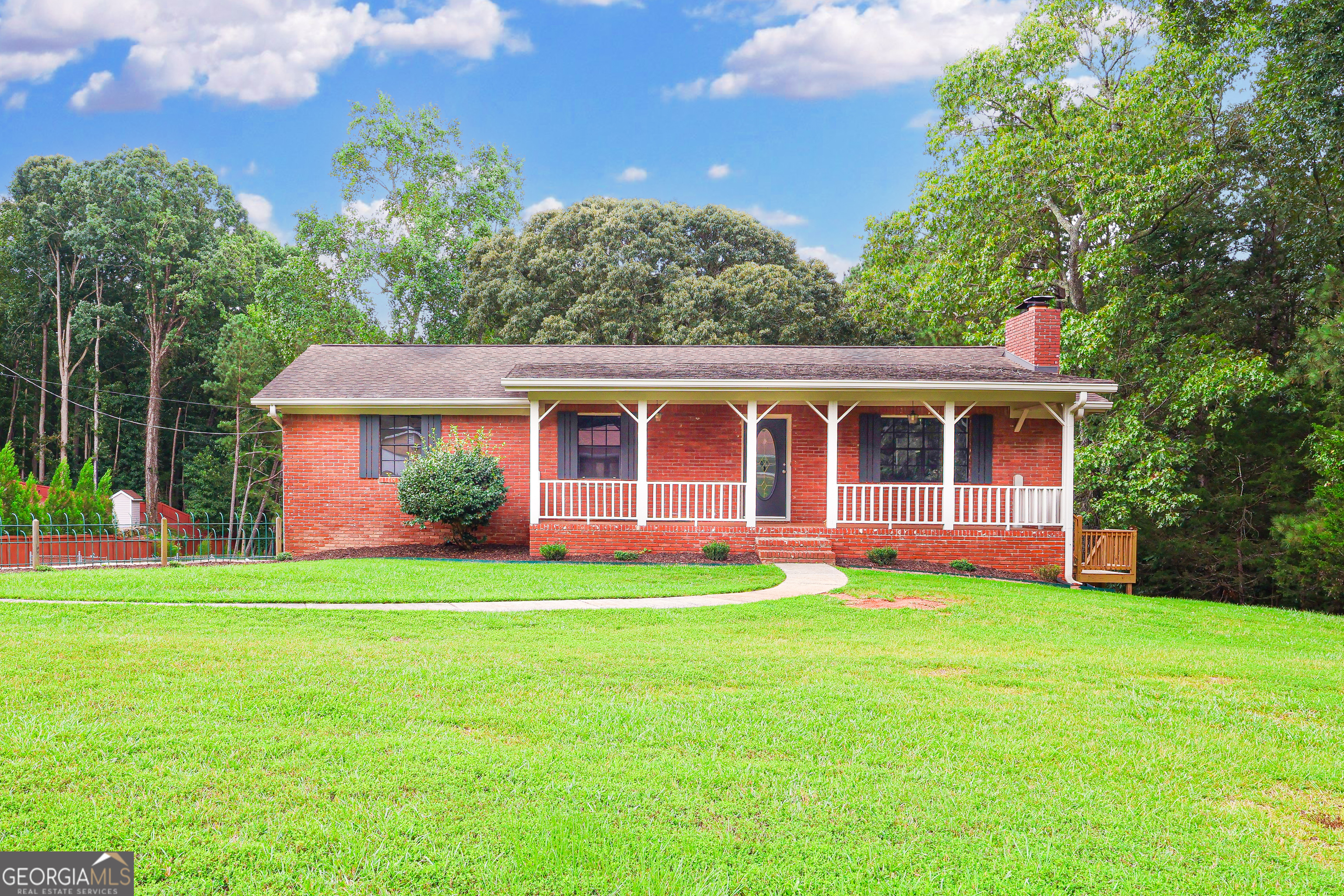 Beautiful Fully Renovated Brick Ranch for Lease on 2 Acres! Now available for lease! This charming brick ranch home with a welcoming front porch sits on a full basement and 2 private acres, offering the perfect blend of updated interiors and peaceful outdoor space-just 22 minutes from the airport and close to Trilith Studios, QTS Data Center, and Peachtree City. Step inside to a completely renovated main level featuring 3 bedrooms and 2 modern bathrooms, all with brand-new LVP flooring throughout. The spacious kitchen shines with new cabinets, sleek granite countertops, and stainless-steel appliances. Two secondary bedrooms share a renovated bathroom with new vanity and a bath/shower combo. The master suite offers two closets and a stunning ensuite bathroom with glass shower and modern finishes. Downstairs, the basement provides flexible space for a rec room, home office, gym, or creative studio. The home also offers not one, but two large garages-perfect for vehicles, storage, or workshop needs. Outside, enjoy a large fenced-in yard with plenty of room to relax, play, or grill - surrounded by the privacy of mature trees and wide-open space. Save money--home is on well so no water bill!