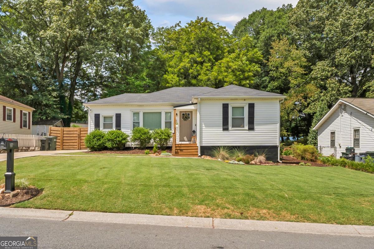Charming Updated Ranch in the Heart of Marietta! Welcome to 87 Otis Street - a beautifully renovated 2-bedroom, 1-bathroom home tucked on a quiet street just minutes from Historic Marietta Square. Bursting with curb appeal, this classic white ranch with black shutters and a cozy front porch is the perfect blend of charm and modern updates. Step inside to discover gorgeous original hardwood floors, fresh paint, and a bright, open layout filled with natural light. The spacious living room connects to a lovely dining area and updated kitchen-ideal for daily living or entertaining. Out back, you'll fall in love with the fully fenced backyard, large deck, fire pit, and beautifully landscaped space-perfect for pets, play, or relaxing evenings outdoors. With too many upgrades to mention, this move-in ready gem is truly one of a kind.