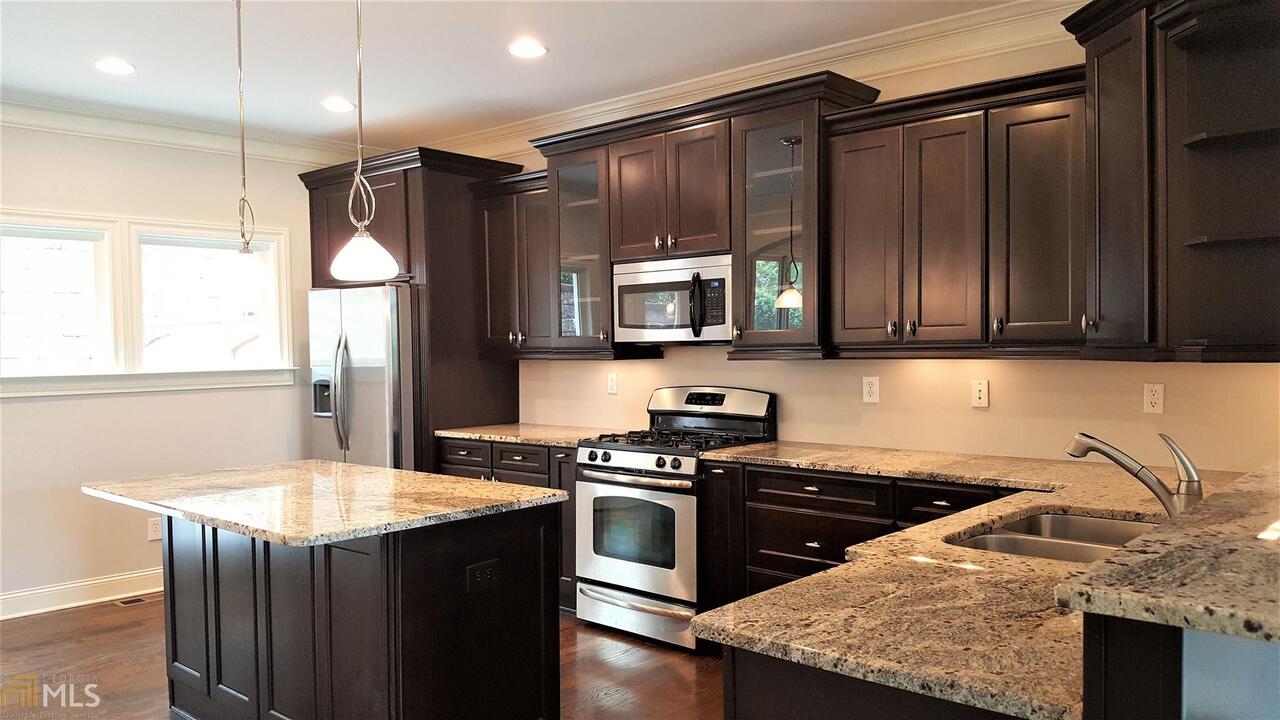 Stunning 3BR|3.5BA 3-Level Townhome nestled in Dupont Commons features an open modern floorplan w/dark hardwood floors, large great room w/fireplace, kitchen w/ Espresso Cabinets & lighting, granite counter top, island, stainless steel appliance, walk-in pantry, dining room w/butler pantry, bath & access to deck. Upstairs offers a spacious master suite w/tile shower, double vanity, walk-in closet; a second bedroom w/private bath, & laundry room. The terrace level offers a 3rd oversized bedroom w/private bath. Convenient to shops, restaurants, & highway.