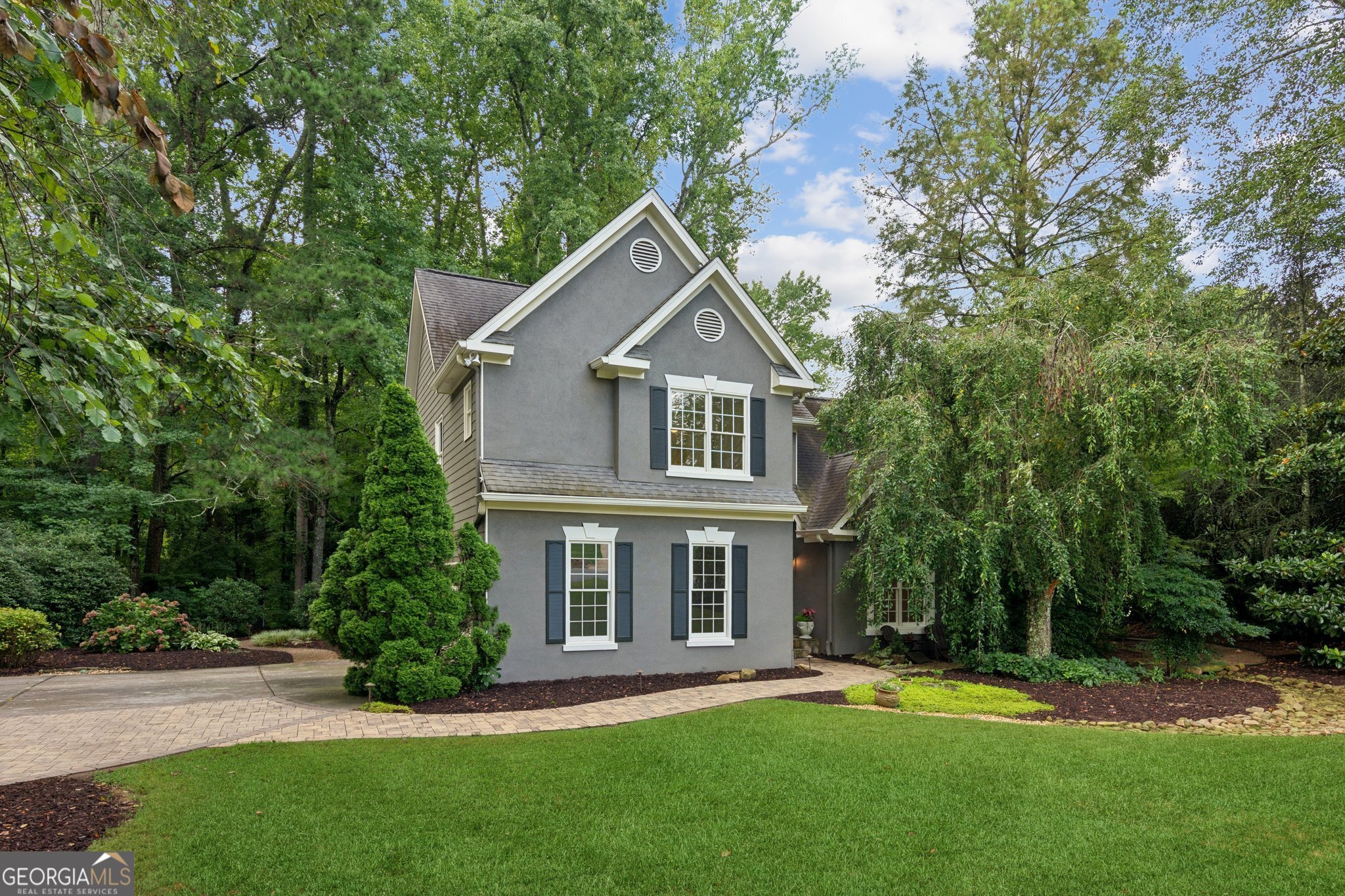 Welcome to your private retreat in this established South Forsyth, Swim & Tennis Community with Nationally Top Rated Schools. This beautifully maintained home sits on a spacious landscaped lot with an additional adjoining lot purchased by the current owners specifically to preserve privacy. From the moment you arrive, you'll notice the tranquility this rare offering provides. Whether you're relaxing on the patio, or warming by the outdoor fireplace, entertaining guests, or simply enjoying time in the yard, you'll appreciate the buffer from neighbors and the peaceful natural surroundings. This home is move in ready with an updated kitchen, newer appliances, freshly painted interior, new carpet and hardwood floors that have been sanded and re-stained. This South Forsyth community offers convenience to shopping, restaurants, library and nationally high ranking public schools. With the flexibility of the additional lot-ideal for expansion, a garden, or simply to protect your peace-this is a truly rare find in today's market.