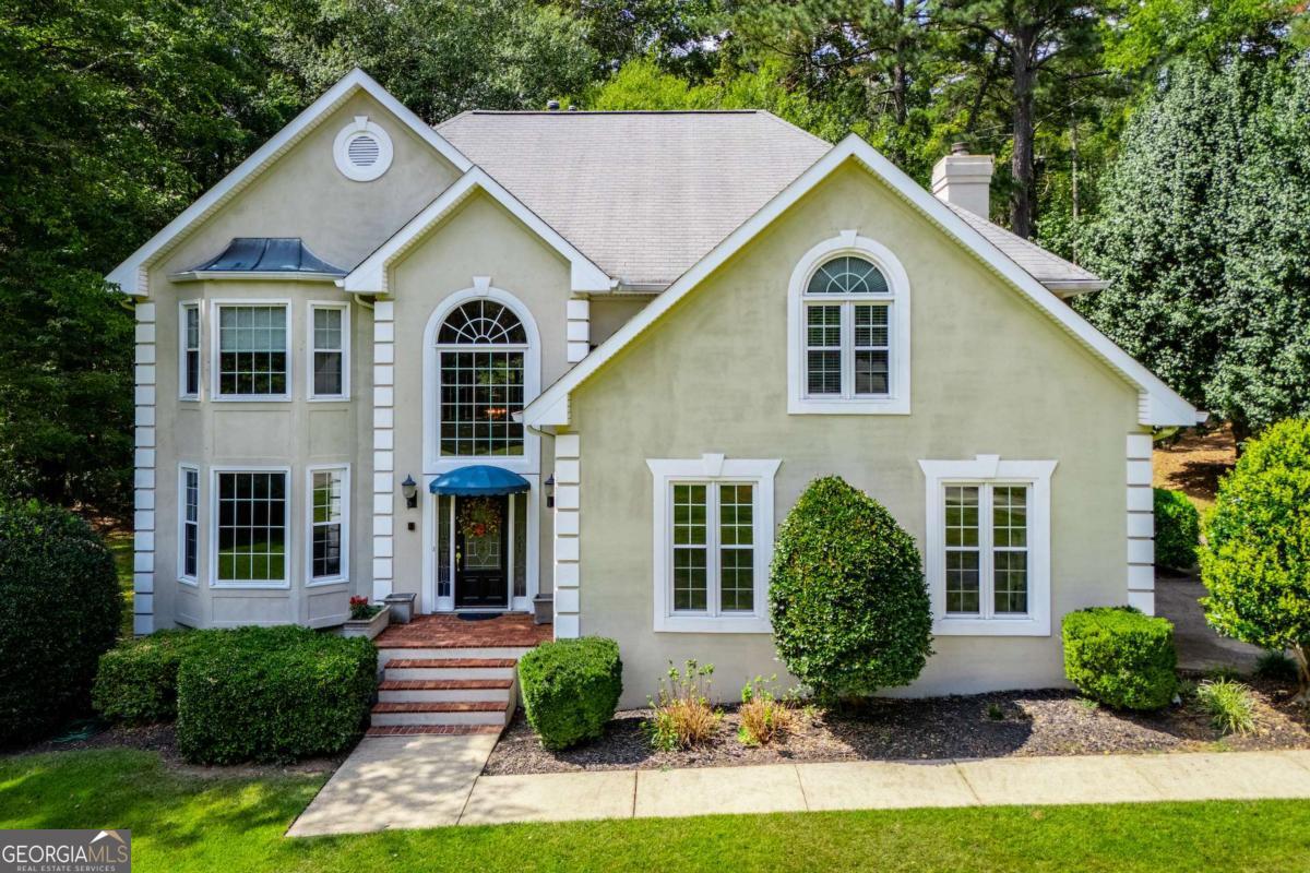 Stunning traditional home in one of Carrollton's best neighborhoods. This one has so much space and a simply gorgeous yard and back deck. On the main level, you'll find a 2-story foyer, formal den, & formal dining, all with hardwood floors, powder room, & family room open to the kitchen. The den has a cozy fireplace surrounded by built ins and a wall of windows for great natural light. The upstairs has an expansive owner's suite with walk in closet and en suite bath, 3 additional bedrooms and another full bath. The estate sized allows the house to sit over 200 feet from the road with a huge front yard and private back yard. There is an attached utility room out back for extra storage, and loads more storage upstairs. Everyone loves the amenities in Smokerise. From the utility field, covered pavillion with picnic tables, lake, creek, playground, and tennis court, there is something for everyone here! This one is ready for you to make it your own!