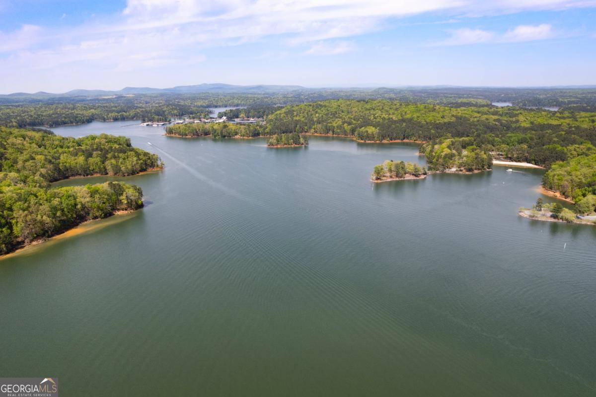 Build your dream lakefront retreat in the unique and vibrant community of Island Mill Road. This rare, buildable lot offers a dock permit and previously featured a 12CO x 12CO platform dock. The property is wooded and slopes down toward the shoreline. Survey and perc test are available for review. No HOA restrictionsCoenjoy the freedom to create your ideal lake lifestyle! Please note: Walk the property at your own risk.