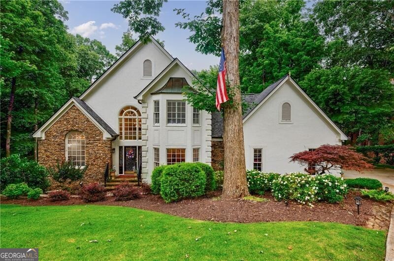 Welcome to this elegant hard-coat stucco Estate home, ideally situated on a serene and quiet cul-de-sac in the prestigious COUNTRY CLUB OF THE SOUTH. A charming exterior with stone accents and a classic beveled glass front door set the tone for the warmth and sophistication that awaits inside. Step into the grand two-story foyer, where natural light and timeless elegance greet you. The formal dining room, adorned with a bay window, provides the perfect setting for both intimate dinners and large-scale entertaining. The spacious Great Room is the heart of the home, featuring vaulted ceilings, a wall of windows, a fireplace with floor to ceiling stack stone, and French doors leading to the main-level porch. Designed for everyday living and seamless entertaining, the open-concept kitchen flows into the breakfast area and Great Room, with easy access to the screened porch-an ideal retreat for morning coffee or evening relaxation. The main-level primary suite is a true sanctuary, complete with a cozy sitting area, two-sided fireplace, and private access to the porch. Upstairs, you'll find three generously sized bedrooms: one with an en-suite bath and two sharing a well-appointed adjoining bath, all with abundant closet space. The fully finished terrace level is an entertainer's dream, offering a second kitchen, large family room, office, yoga/exercise room, guest bedroom, and full bath. Step outside to the covered terrace-level porch, featuring a custom stay-dry gutter system-perfect for enjoying the outdoors in any weather. This move-in ready home offers luxury, comfort, and lifestyle-all within one of Atlanta's most sought-after gated communities. Residents enjoy resort-style living with 24/7 manned security, a Jack Nicklaus-designed golf course, clubhouse, swim and tennis facilities, and a welcoming neighborhood atmosphere.