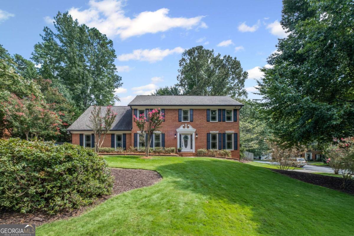 Welcome to your dream home in Peachtree Corners! Nestled on a spacious, level corner lot in the highly sought-after Spalding Corners neighborhood, this all-brick beauty blends timeless curb appeal with modern updates and incredible versatility. Inside, the renovated main level steals the show. Gleaming refinished hardwood floors flow through a bright, open layout designed for today's lifestyle. The freshly remodeled chef's kitchen is a stunner, showcasing a long quartz island with single-well sink, sleek backsplash, and thoughtful extras like a hidden spice cabinet, pull-out shelving, and soft-close cabinetry. A sunlit dining room adjoins seamlessly, perfect for gatherings both large and small. The heart of the home, the great room, spans front to back, anchored by a striking marble-look fireplace surround , built-ins, and floating shelves. For entertaining, the stylish custom bar is perfectly tucked away yet close at hand. Even the laundry/mudroom has been reimagined with modern upgrades! From the main living areas, step directly outside to the private, family-friendly backyard, complete with a darling multi-use shed. Upstairs, hardwoods continue into the serene primary suite with renovated bath, while three spacious secondary bedrooms share a hall bath enhanced by a smart dual vanity room for ultimate convenience. Downstairs, the finished terrace level with kitchen opens endless possibilities-ideal for in-laws, guests, or even rental income-with its own private entry and second driveway. Living here means more than just a home, it's a lifestyle. Spalding Corners offers an optional swim and tennis club featuring four lighted tennis courts, pool with diving board and baby pool, playground, volleyball court, and the lively Spalding Corners Sharks Swim Team. Year-round social events like the Spring Fling, Luau, July 4th Parade & Party, and Chili Cook-Off bring neighbors together and create a vibrant sense of community. All of this in an unbeatable location-minutes to The Forum, Peachtree Corners Town Center, top-rated schools, and everything the area has to offer. Don't miss this rare opportunity to own a beautifully updated home in one of Peachtree Corners' most welcoming neighborhoods!