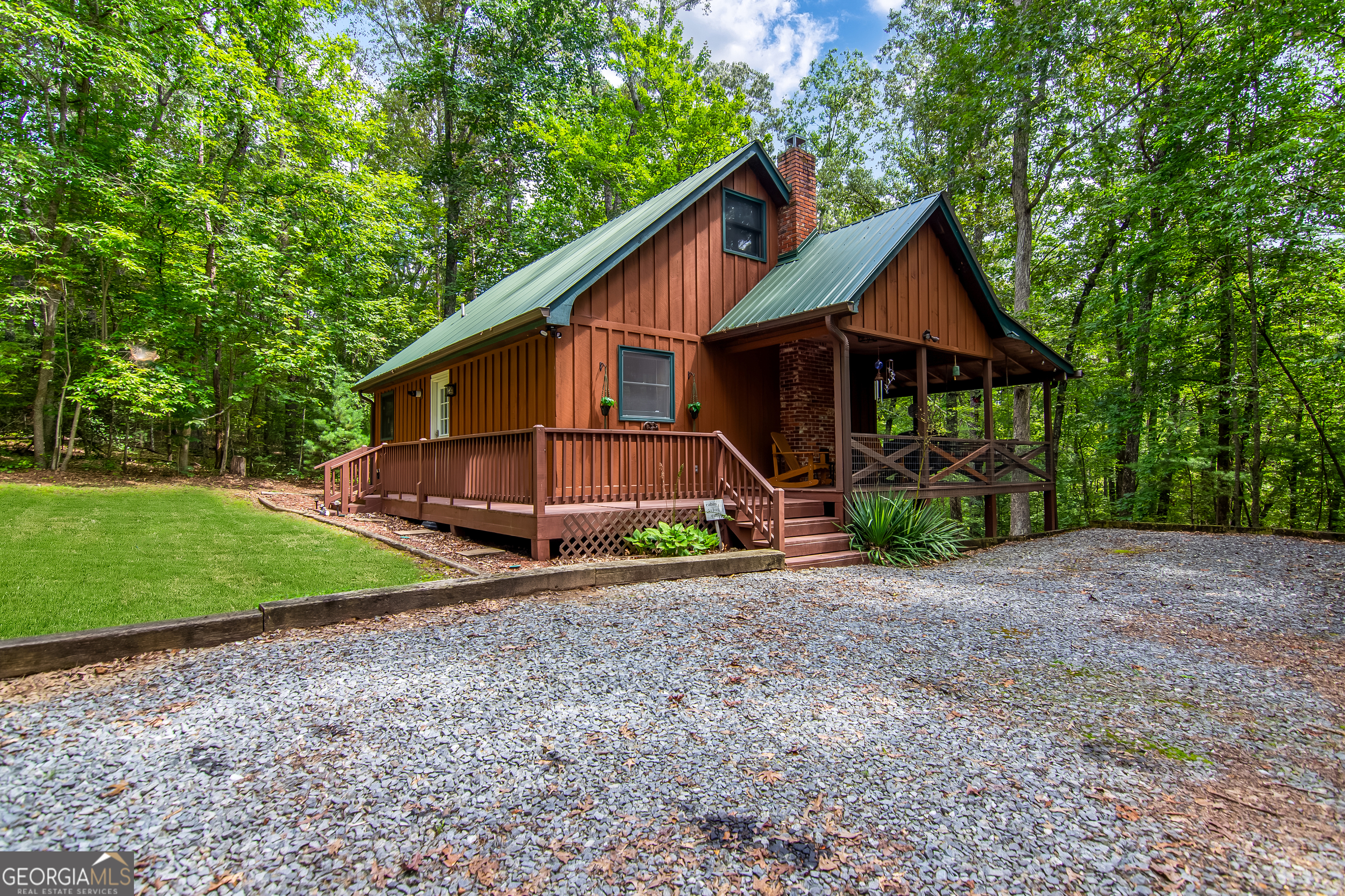 Nestled on over two private,level wooded acres, this adorable cabin offers the perfect blend of charm and comfort! Step inside to find the master and laundry conveniently located on the main level. The open layout makes for a cozy living space ideal for gathering, while outside, a firepit awaits for evenings under the stars. Recent upgrades include new appliances, tankless water heater, new gutters, new screws on metal roof , HVAC and more! Furnishings are negotiable making this an easy turn key option! Whether you are searching for a short term rental investment, a peaceful retirement home or your own private mountain escape, this property checks every box. Call today for an appointment!