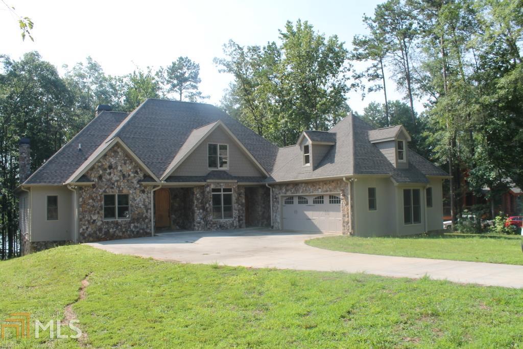 Luxury Lake Hartwell Home! 7 Bedrooms, 4.5 baths- Great for Full Time Living or Family weekend retreat! It features hardwood flooring on the main level, stacked stone fireplace in the family room & sun room, master suite has a huge over sized closet, master bath has double vanities, a large tile shower. Complete finished basement with 10' ceilings, large rec room with ceramic tile and media room with wet bar. Level walk to the large body of water that features a 1 slip covered boat dock. Call today for appointment.