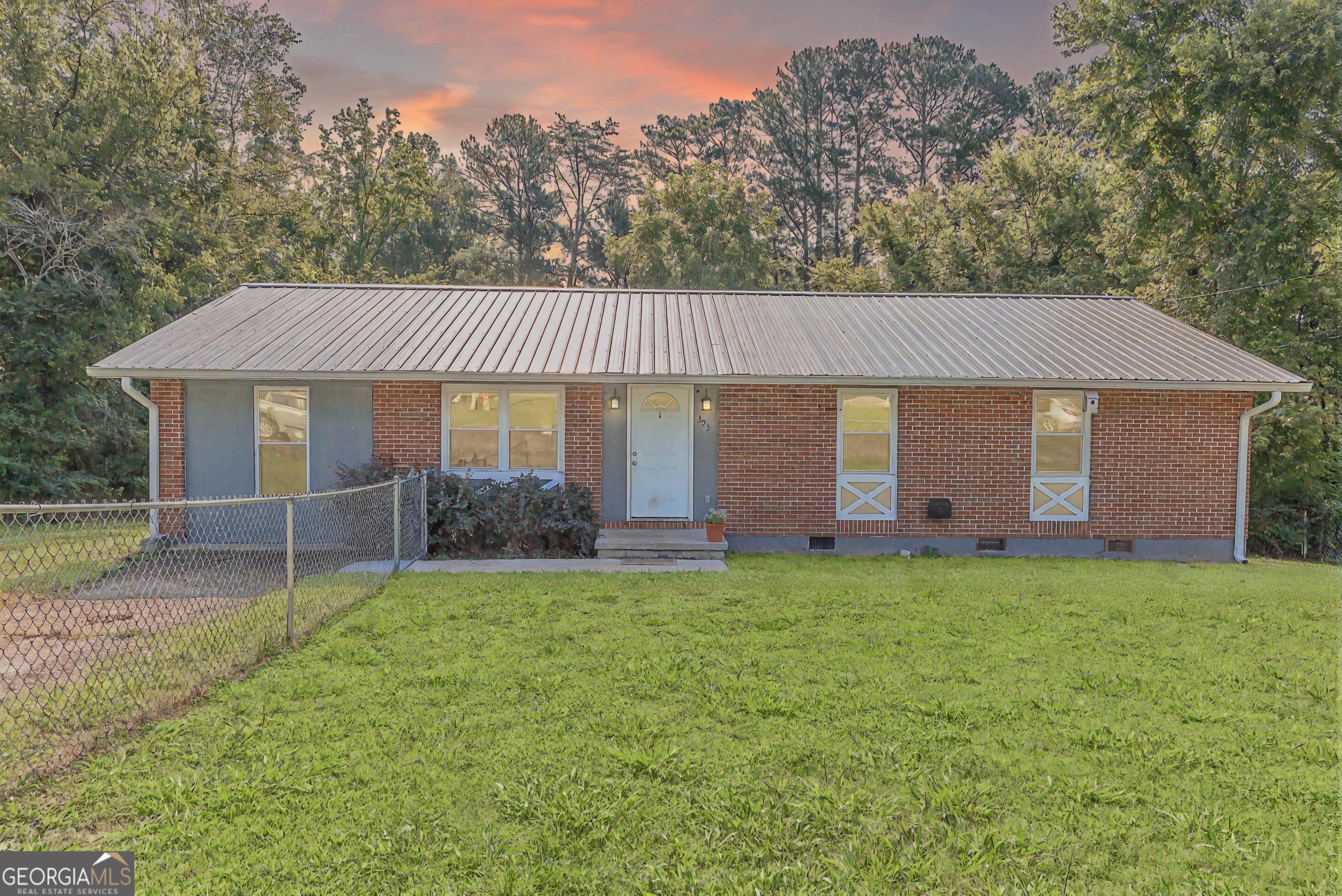 Get ready to fall in love with this stunning, move-in-ready, one-level rancher that perfectly blends Southern charm with modern city vibes! Nestled on a low-maintenance, level lot, this home is your ticket to easy living with all the excitement of the city just minutes away. Step inside to a bright, open living area that seamlessly connects to a versatile multipurpose room-perfect for a home office, cozy reading nook, or hobby space. The sleek kitchen shines with stainless steel appliances, crisp white cabinets, and durable LVP floors that flow through the main areas, adding style and practicality. Three cozy bedrooms with soft carpet floors are ideal for unwinding, while the full bathroom dazzles with elegant marble floors, and a convenient half-bath makes hosting guests a breeze. A spacious laundry room keeps chores simple, and the sturdy metal roof ensures long-lasting durability. Outside, a fully fenced yard wraps around the home, offering privacy and a serene spot for relaxing or entertaining. You're just minutes from Ringgold, I-75, and the city's best-think tasty restaurants, lively concerts, and shopping galore, including a nearby Walmart. This rancher is the perfect mix of comfort, low-maintenance living, and unbeatable location, ready for you to move in today. Don't miss out on this Southern gem!